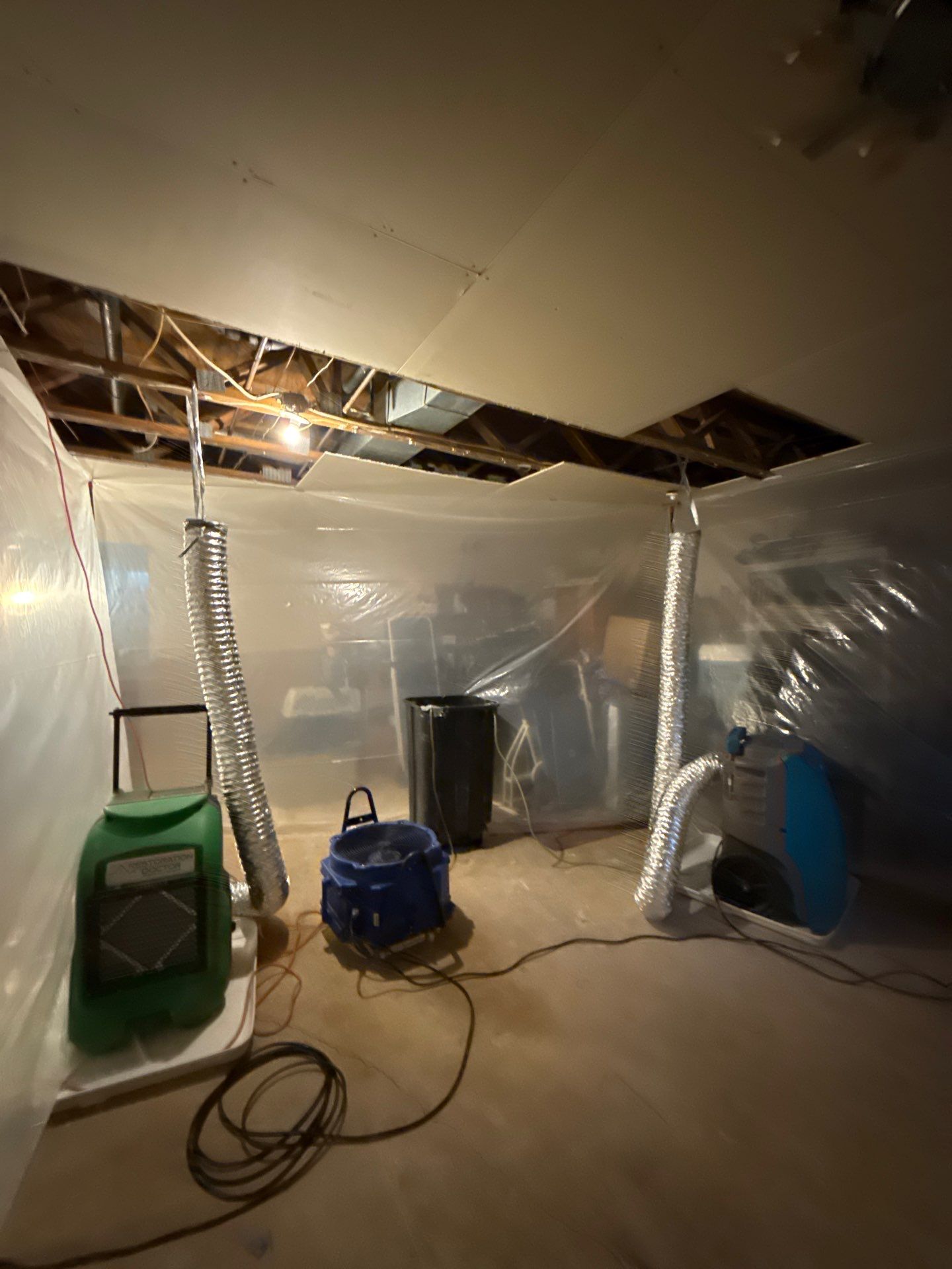 Standing water extraction underway within containment during Leesburg mold remediation.