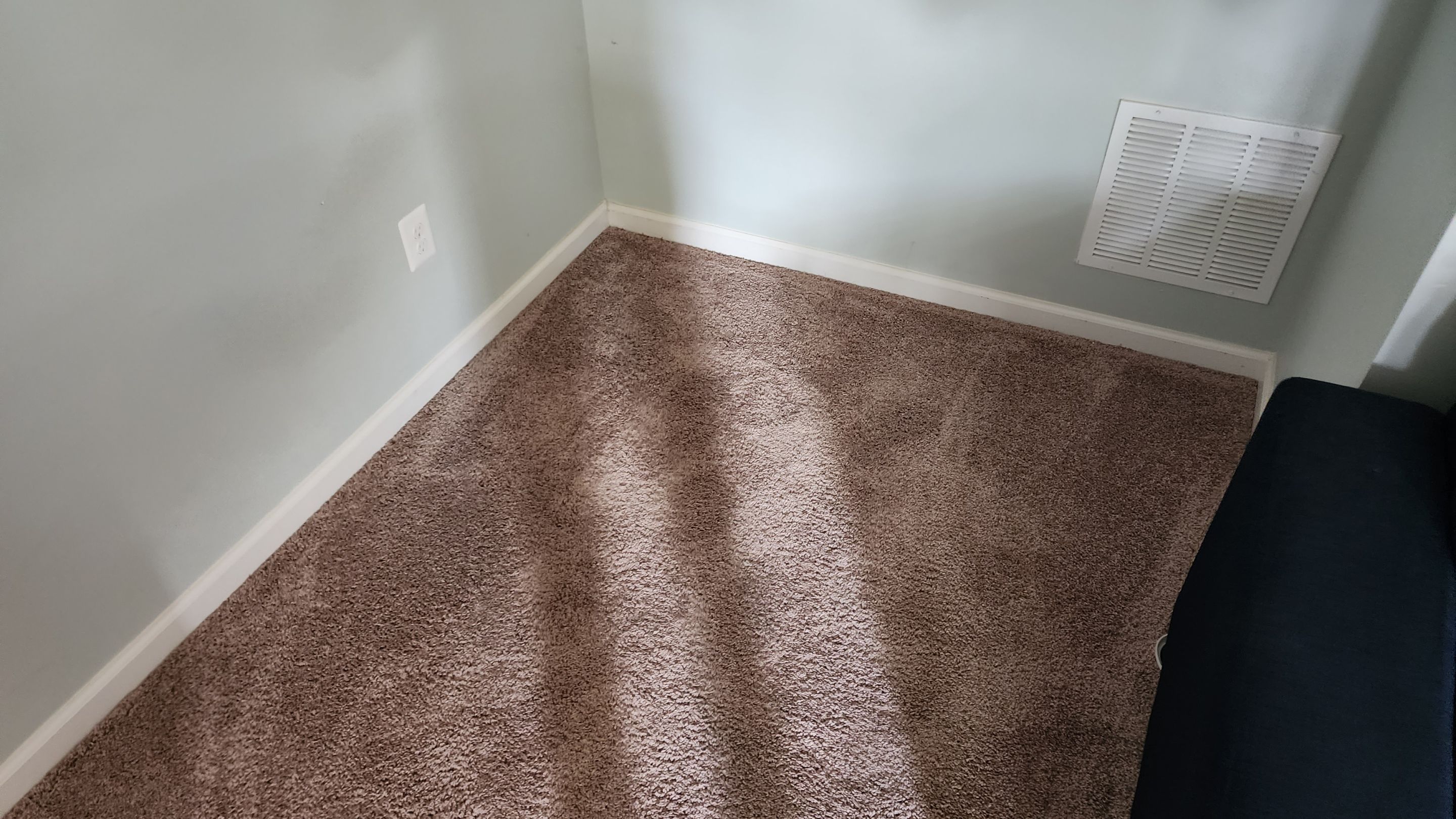 Water-damaged carpet and flooring in Ashburn home with dehumidification equipment positioned for structural drying.