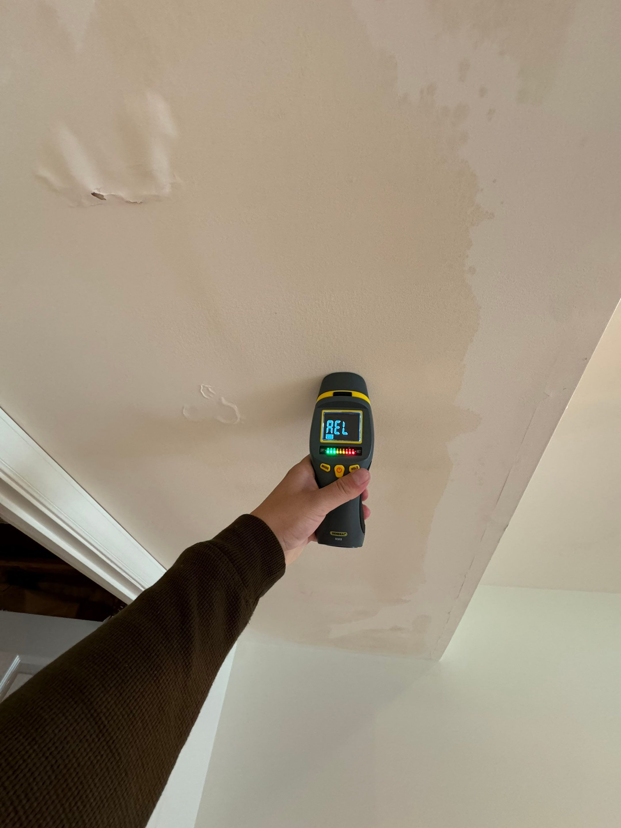 Water-damaged carpet and flooring in Reston home with dehumidification equipment positioned for structural drying.