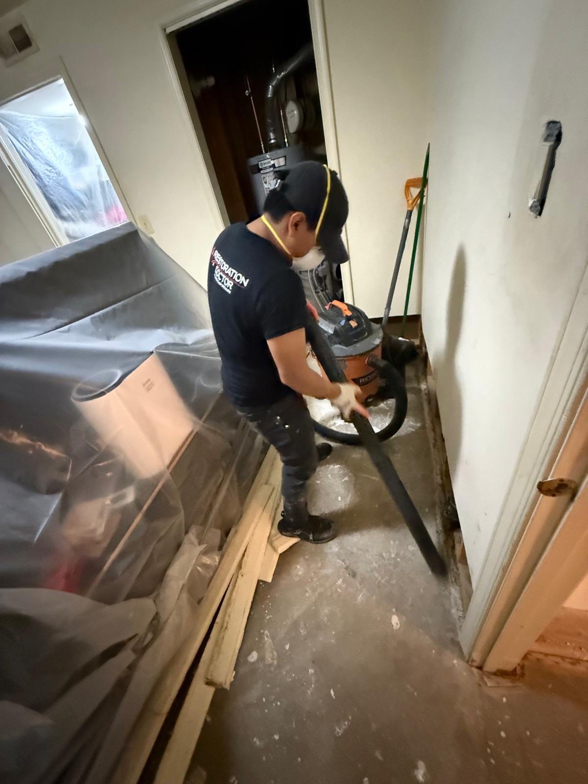 Standing water extraction underway in Centreville water damage restoration, initial assessment phase.