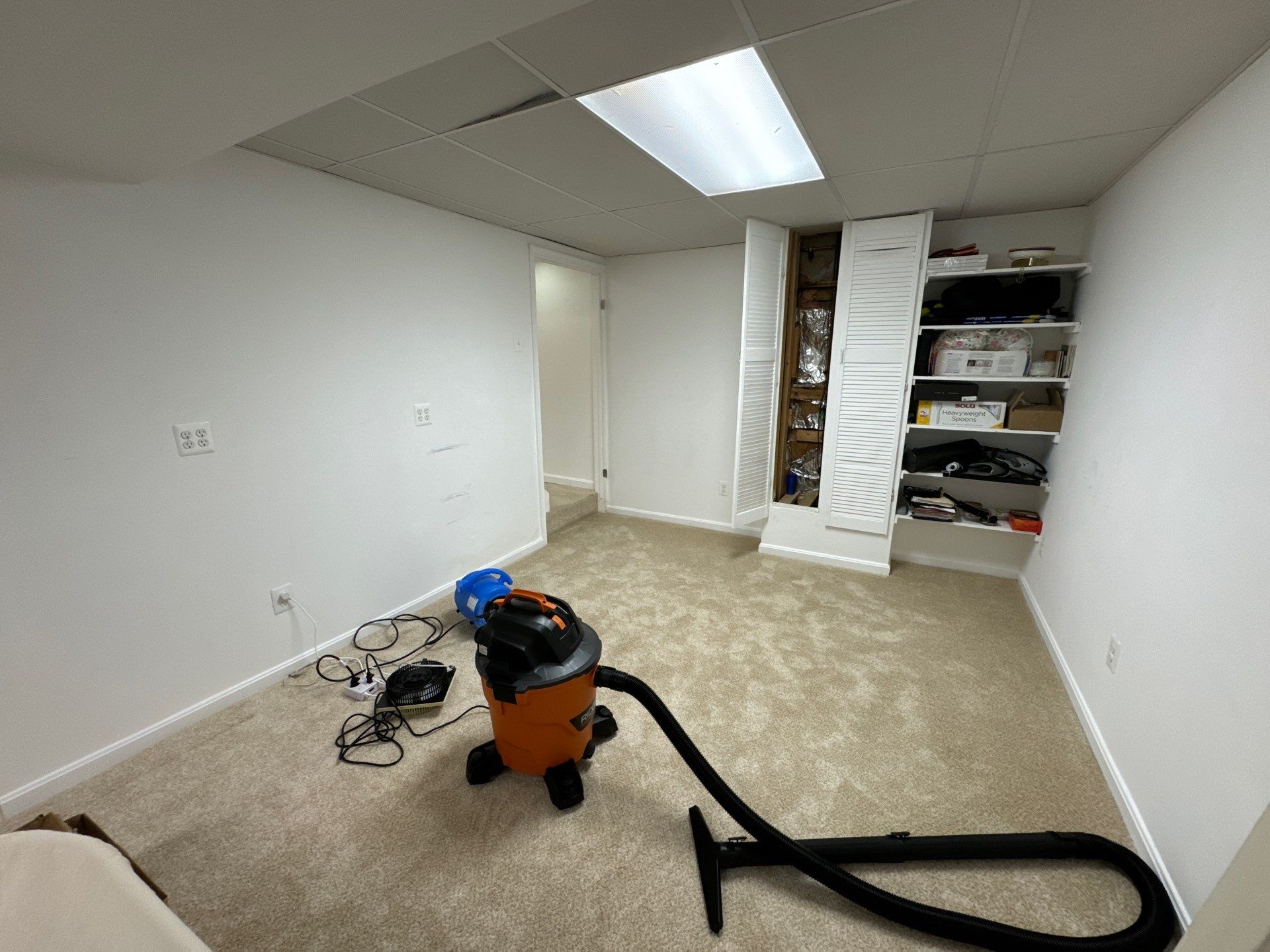 Dehumidification equipment positioned to manage moisture levels during structural drying phase.