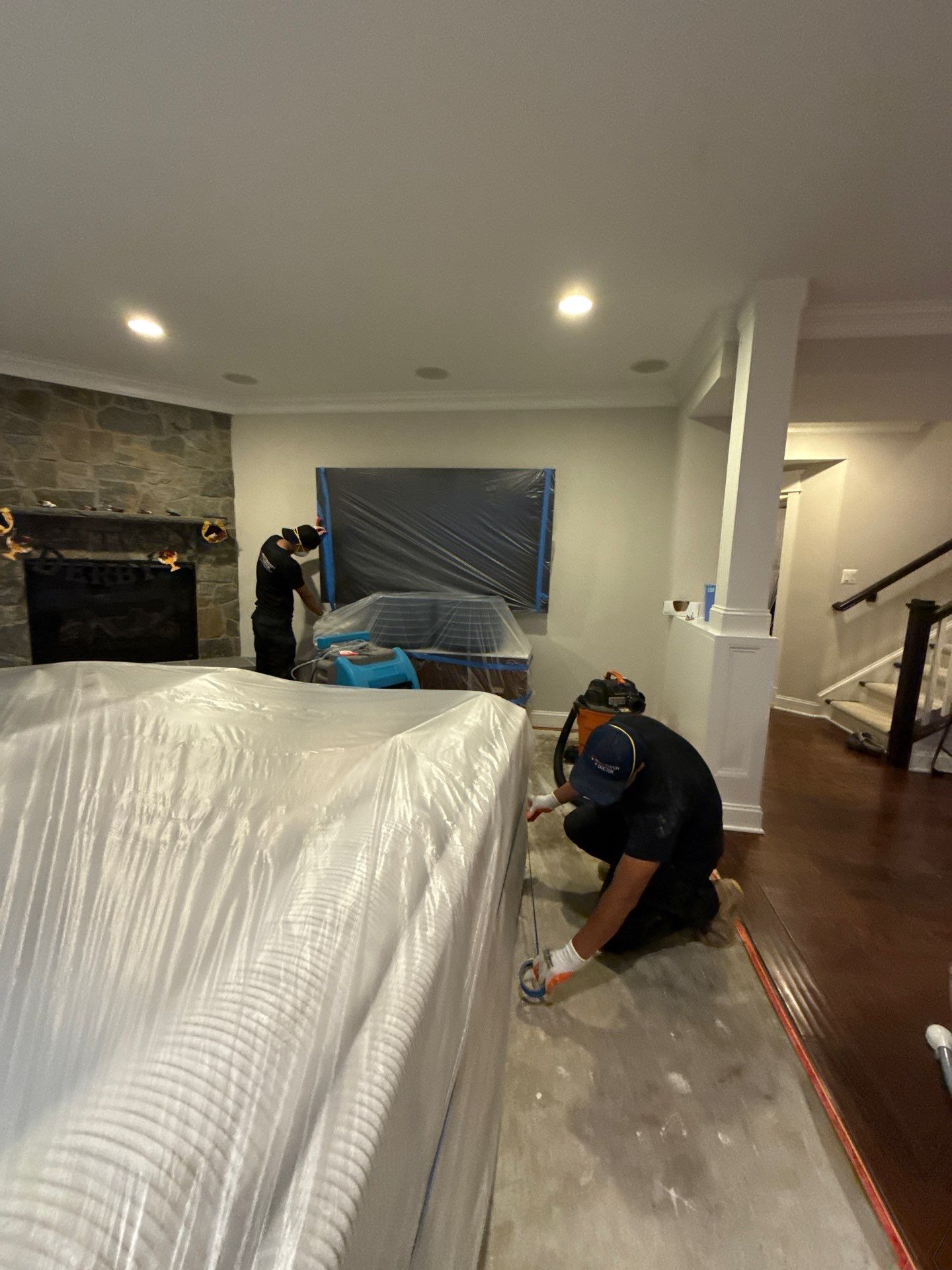 Mid-stage drying setup showing dehumidifiers and air movers positioned for moisture extraction.