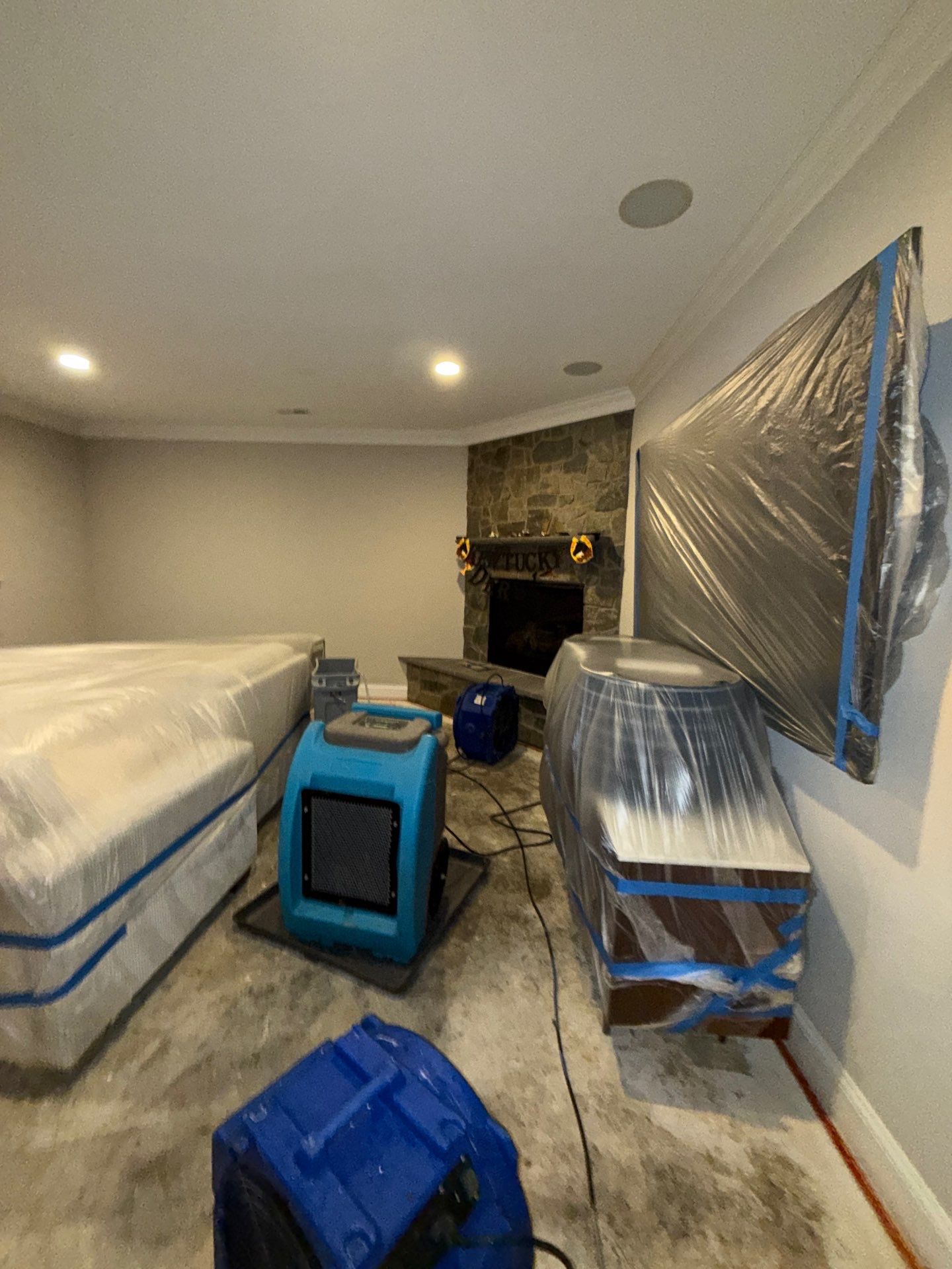 Advanced drying phase with equipment repositioned to address remaining moisture in subfloor and framing.