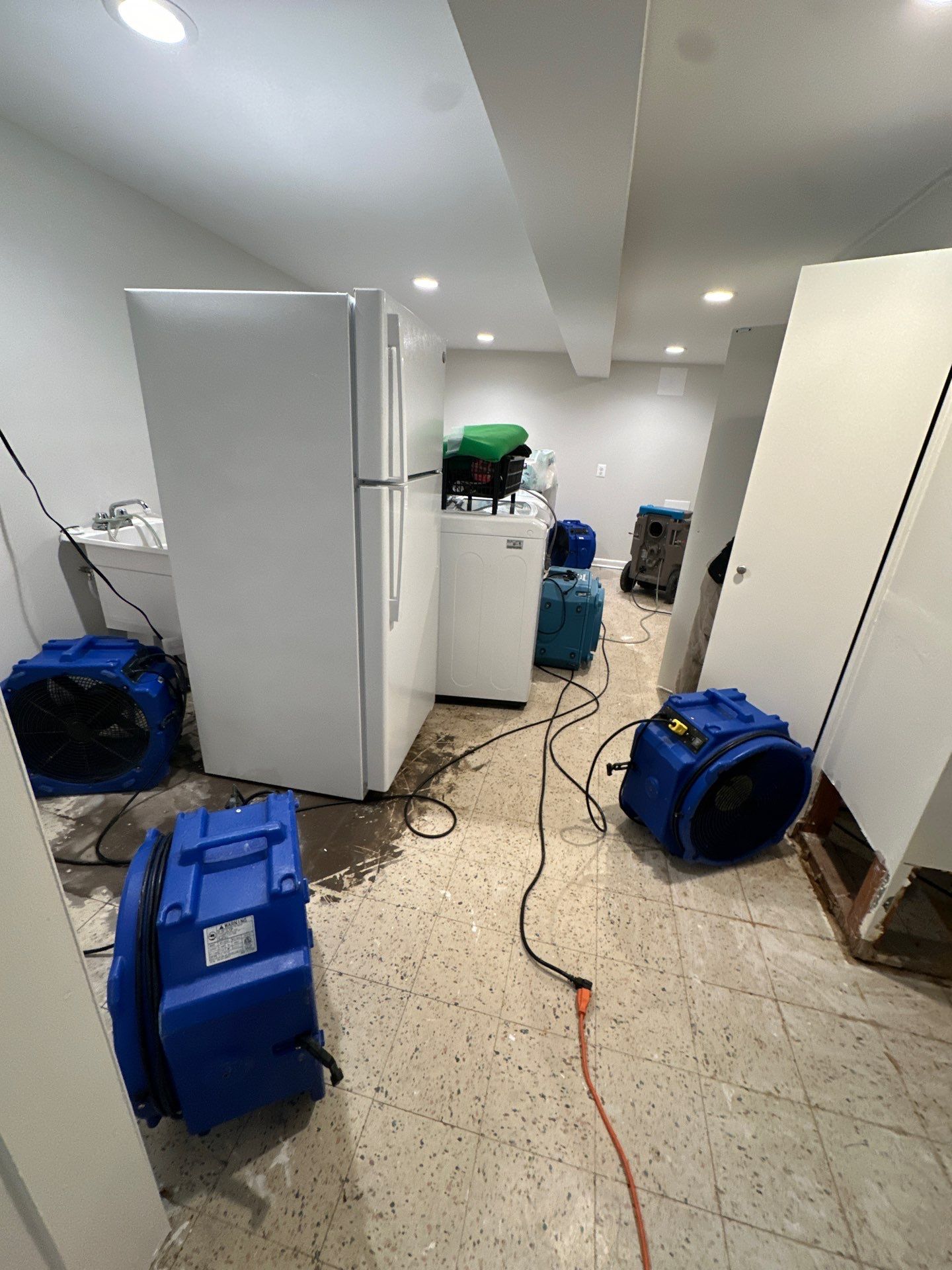 Final-stage water restoration in Falls Church with structural drying complete and equipment removal underway.