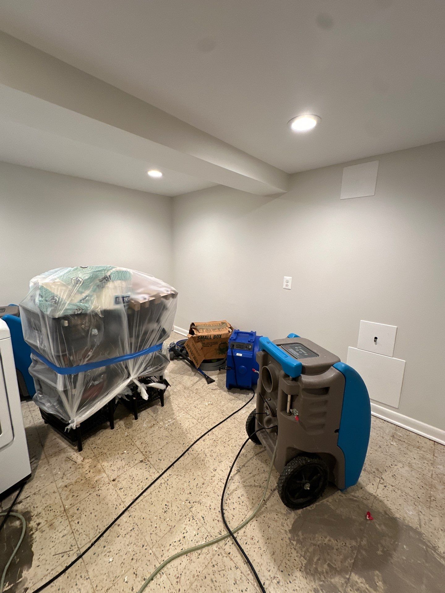Dehumidification equipment positioned for structural drying phase of water damage remediation.