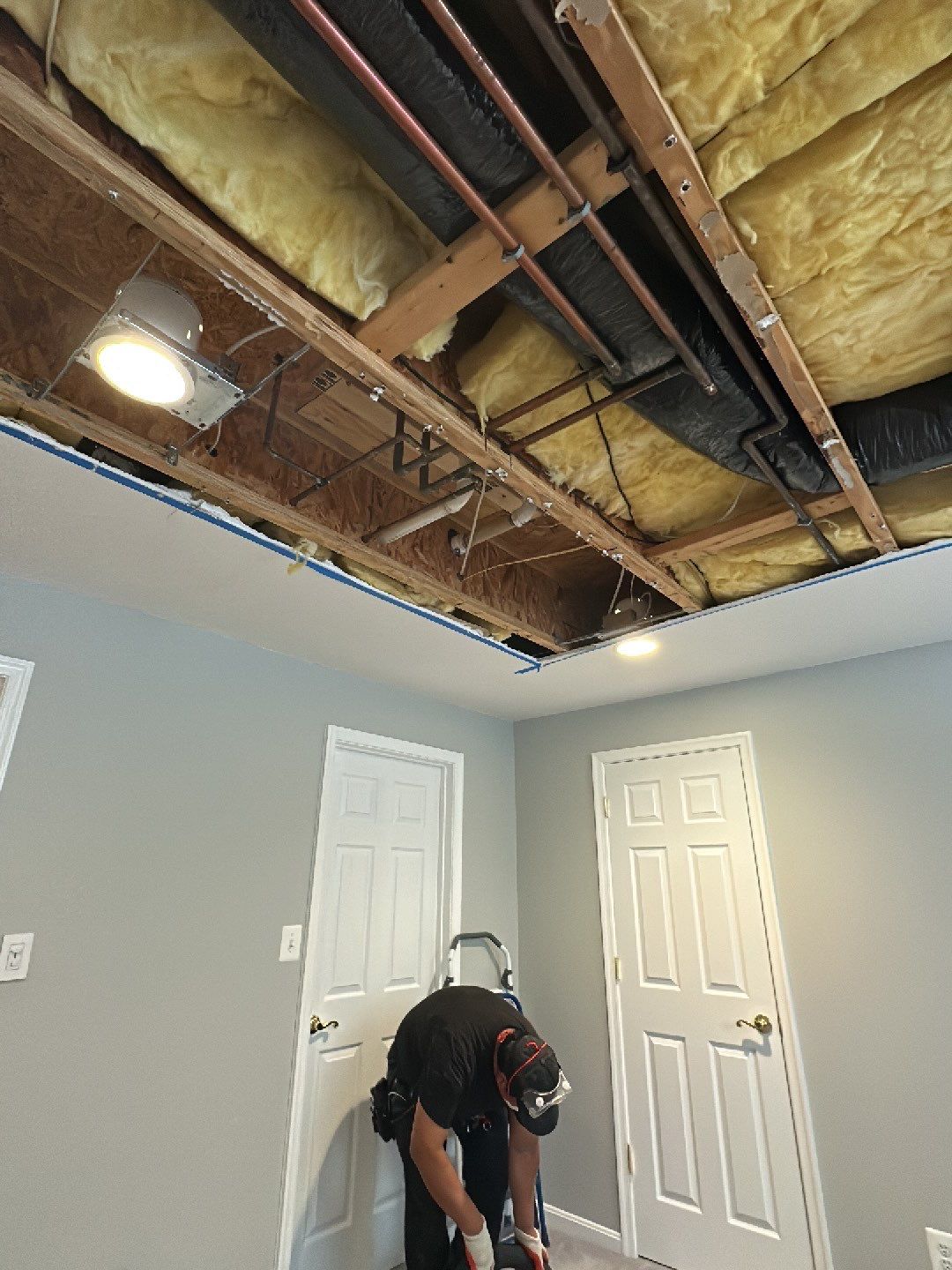 Standing water extraction underway in Arlington water damage restoration, wet flooring exposed.
