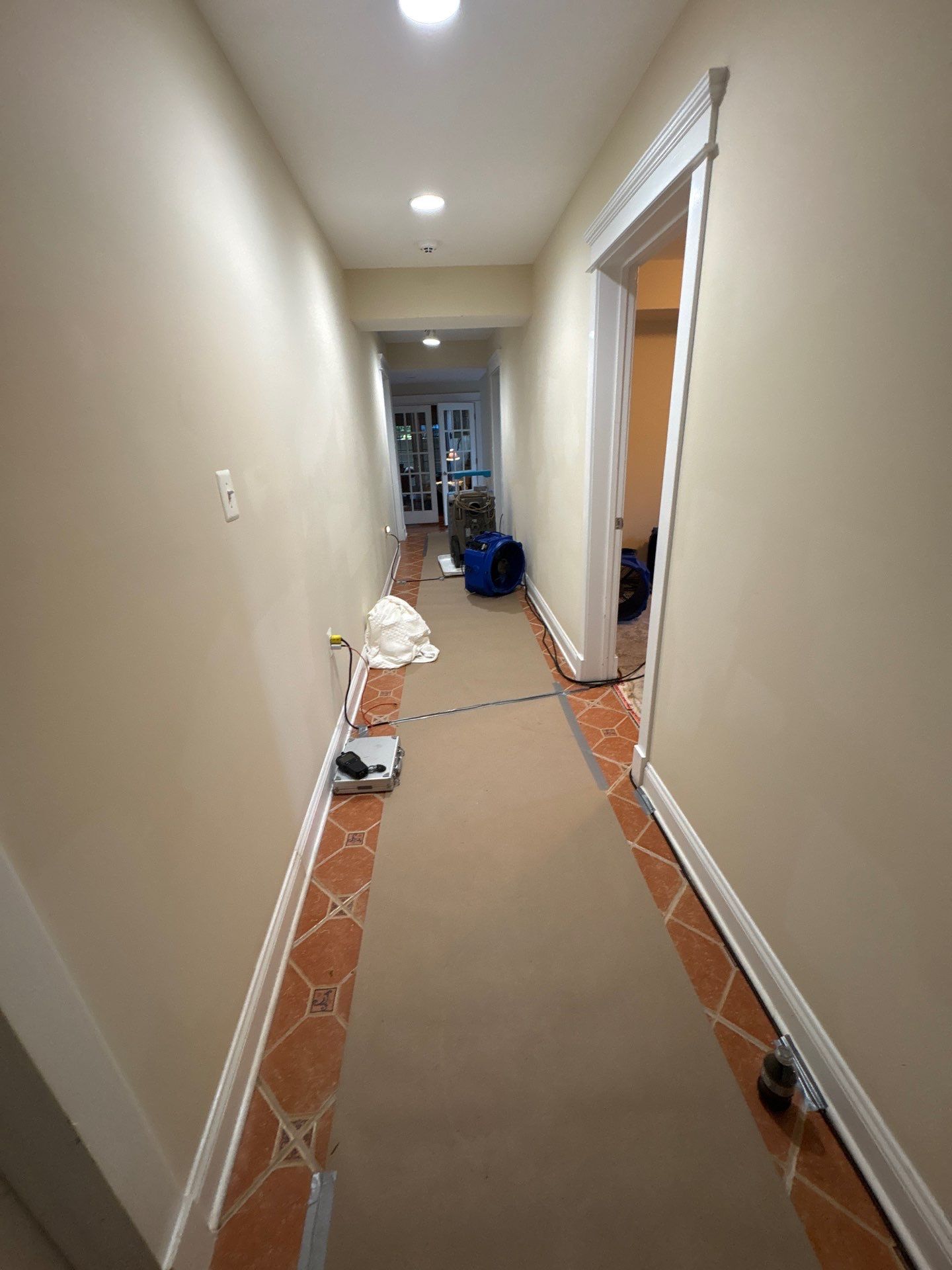 Drying phase of Arlington water restoration showing dehumidifiers and air movers in place.