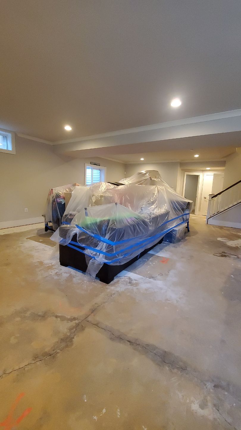 Structural drying continues with equipment positioned to reach wall cavities and subfloor areas.