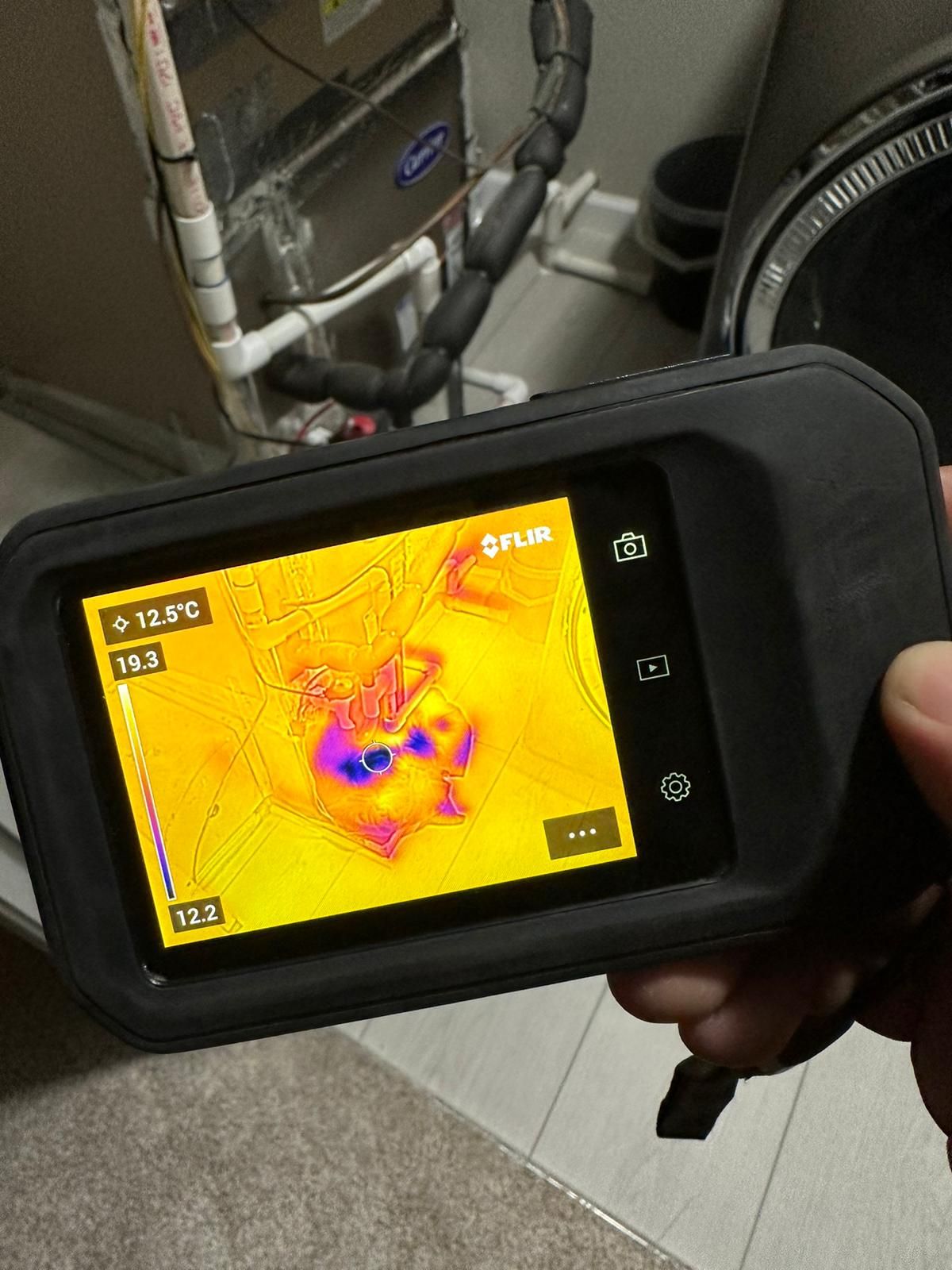 Thermal imaging reveals moisture distribution across wall cavity during Alexandria water damage assessment.