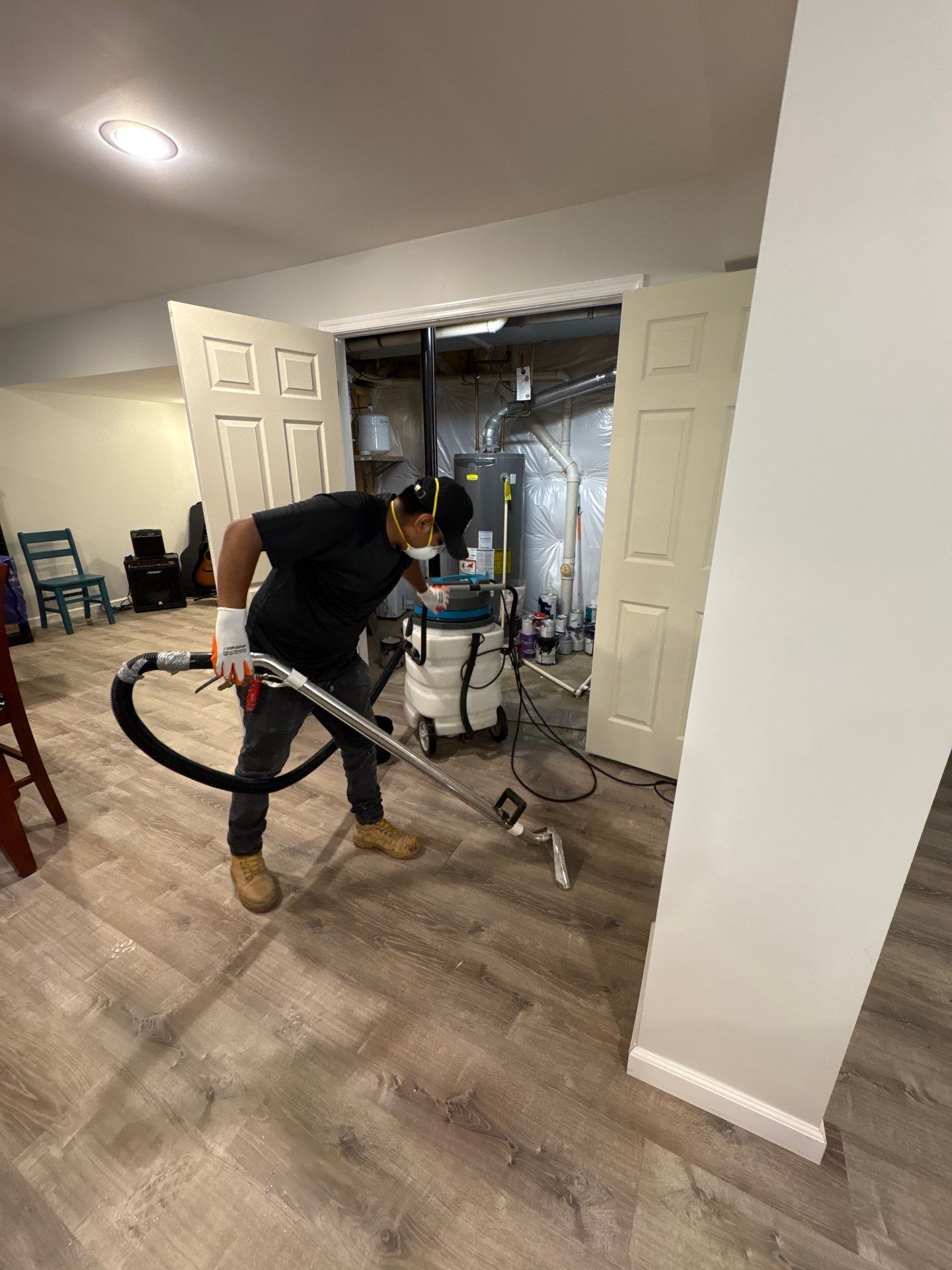 Wet carpet and padding removal underway as part of flooring remediation protocol.