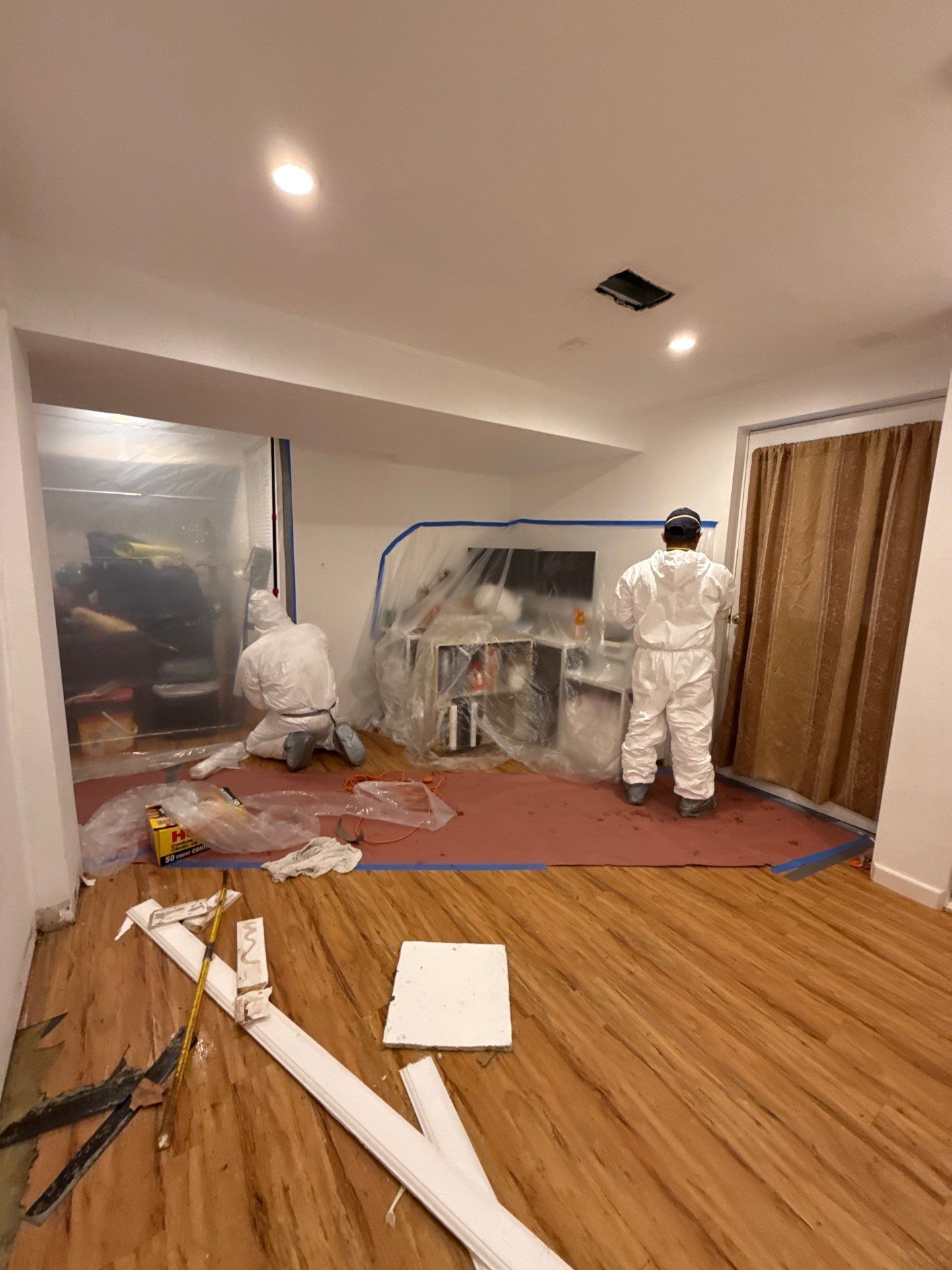 Drying process underway with dehumidification equipment managing moisture levels in sealed work zone.