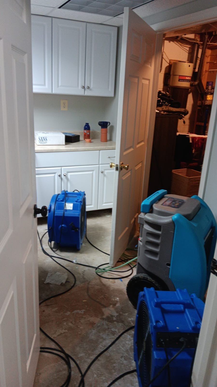 Flooring removal and structural drying in progress as part of mold remediation scope.