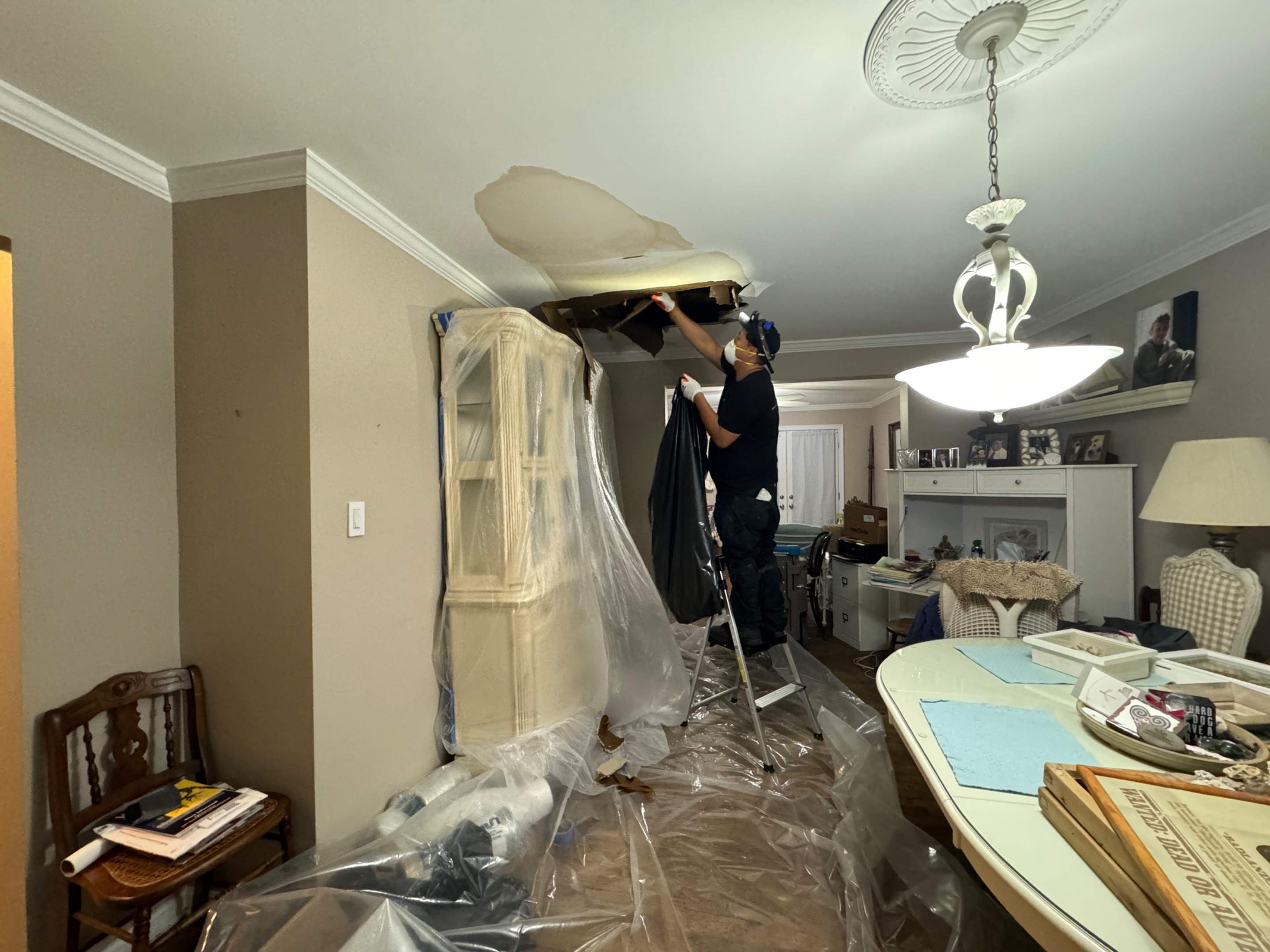 Ceiling repair in progress with contents protection measures in place during Church mold remediation.