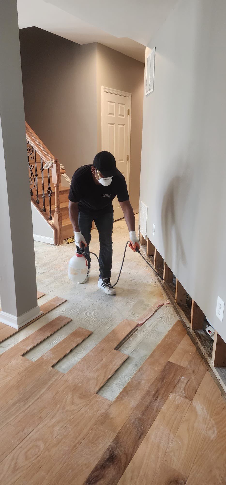 Water-damaged carpet and flooring in Ashburn home with dehumidification equipment positioned for structural drying.