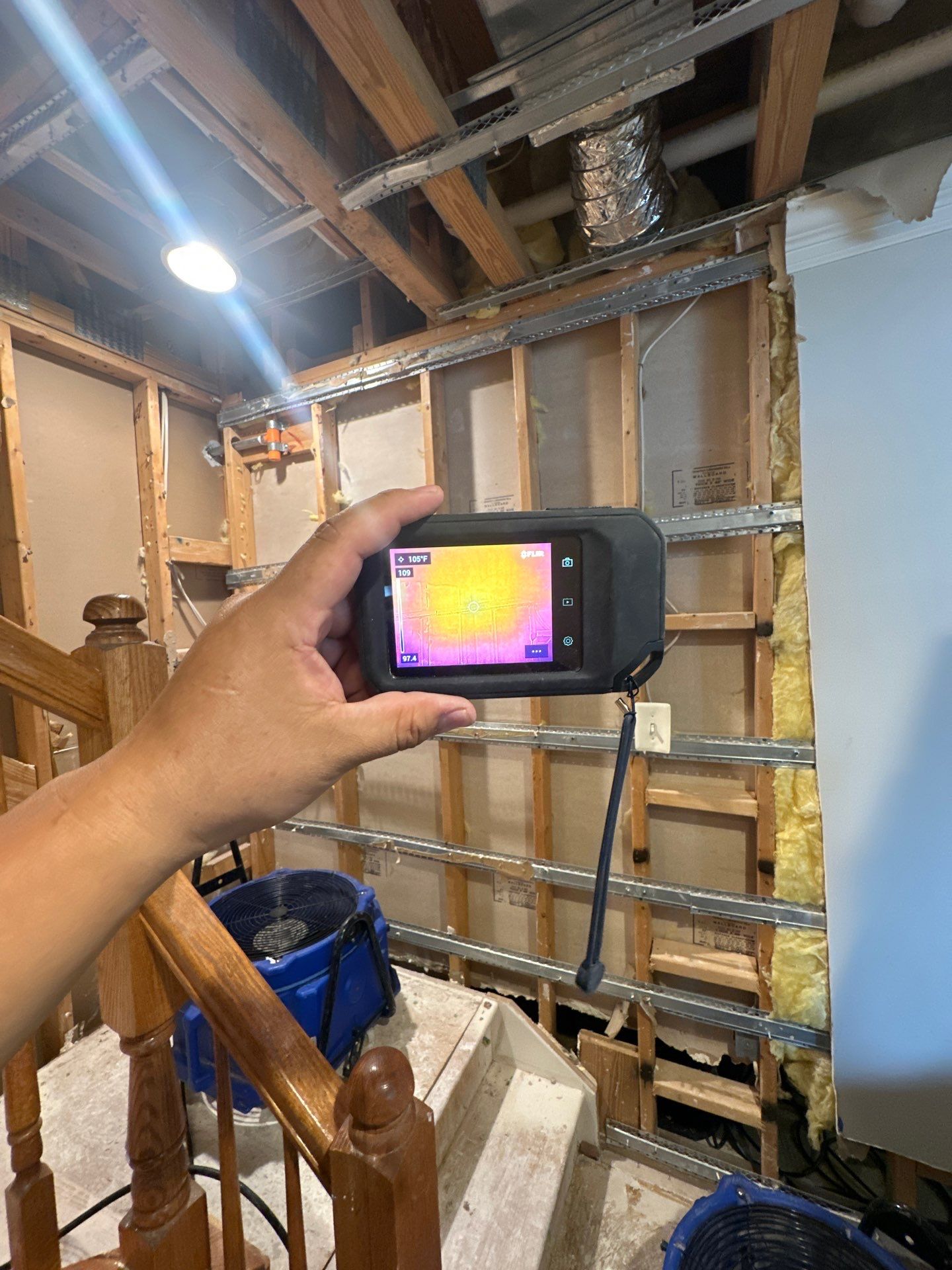 Moisture inspection equipment positioned on structural surface during drying phase.