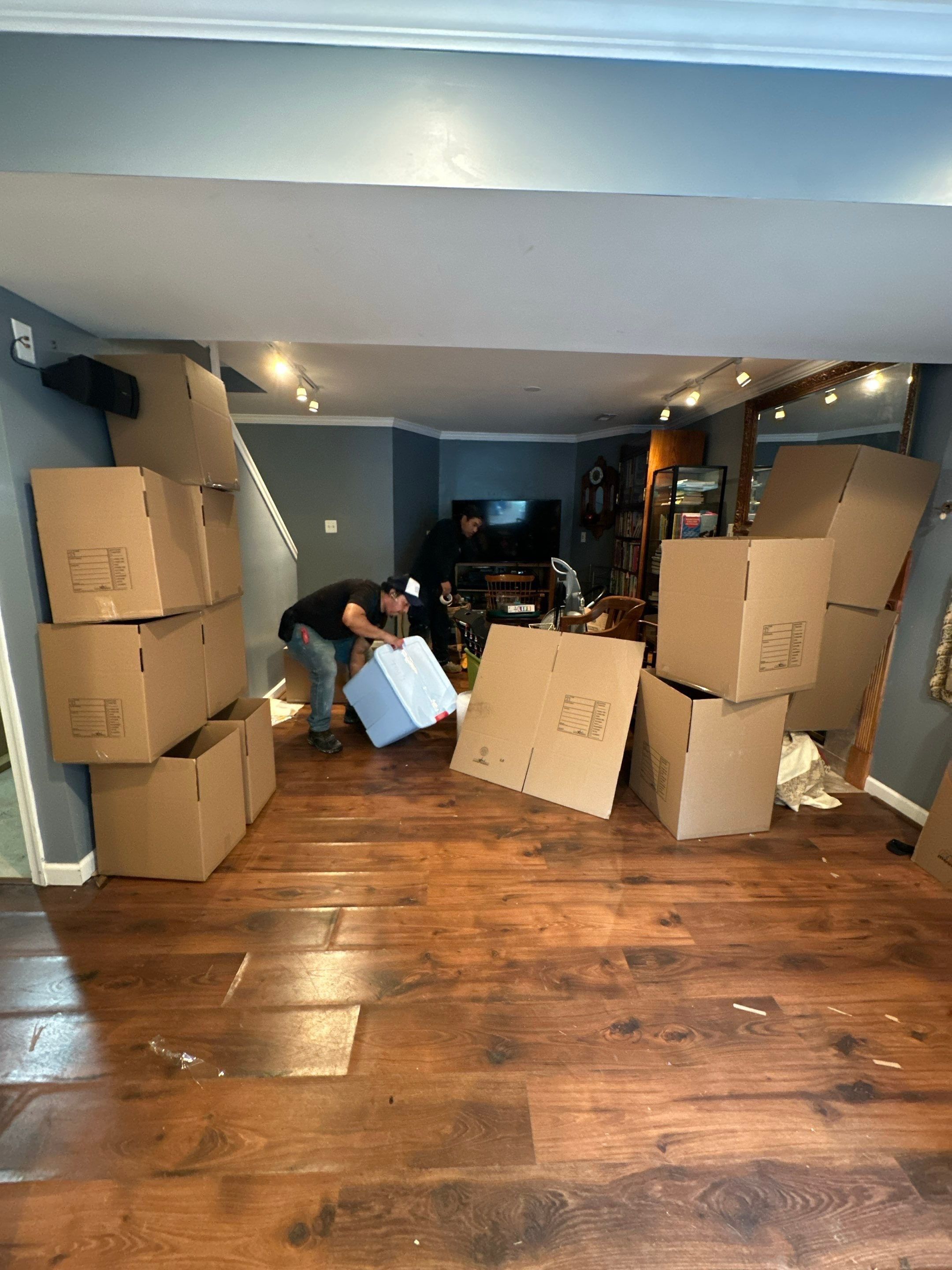 Standing water extraction underway in Woodbridge water damage restoration, removing pooled water from flooring.
