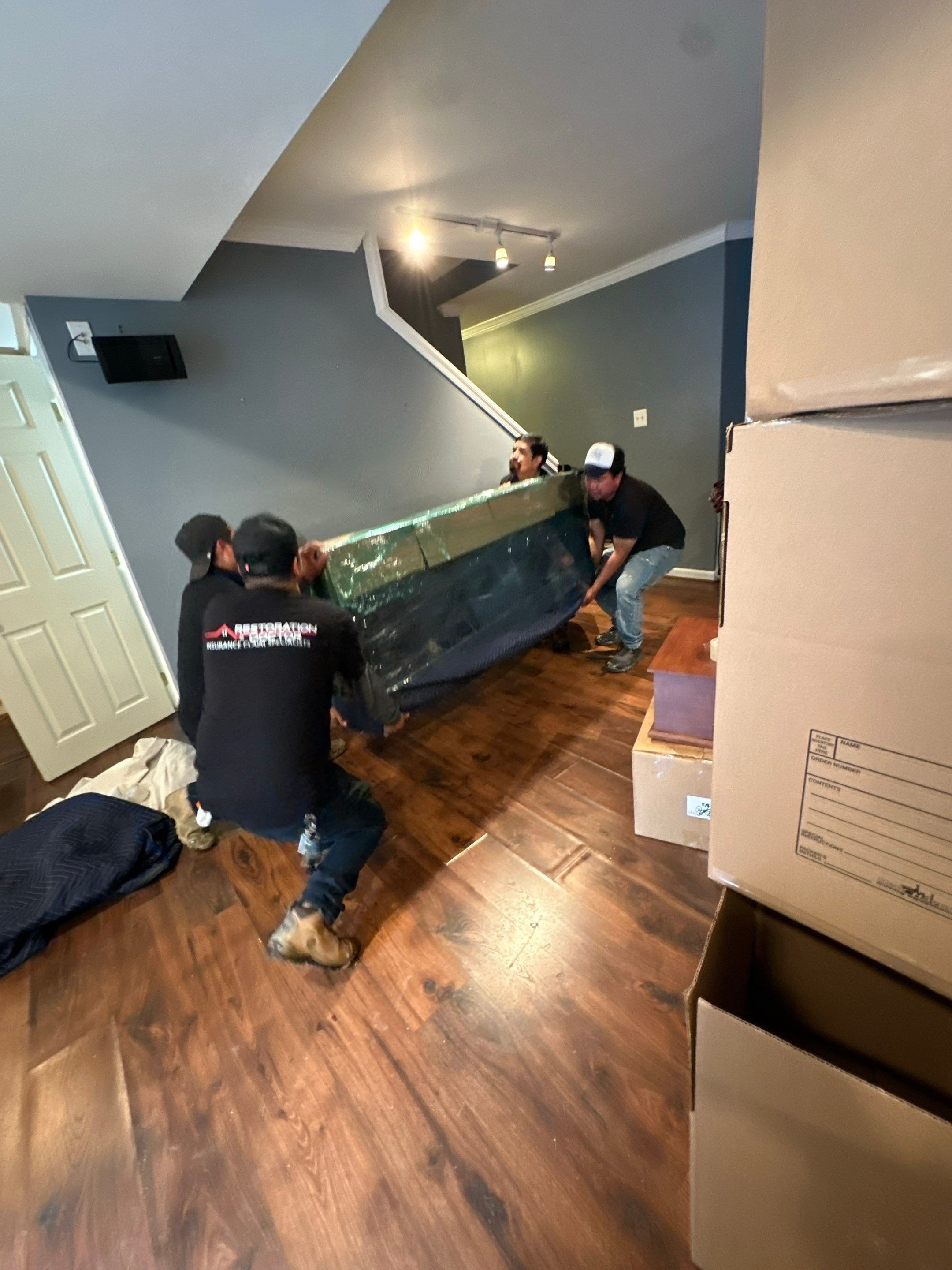 Air movers and dehumidifiers working in tandem to accelerate evaporation from walls and subfloor.