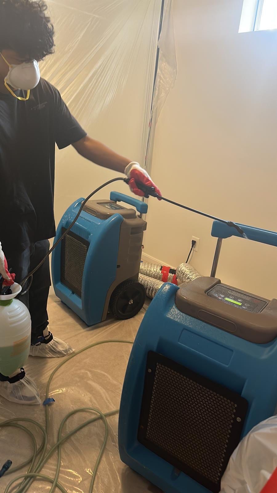 Mid-stage water damage restoration showing containment barrier maintaining isolation during the drying process.