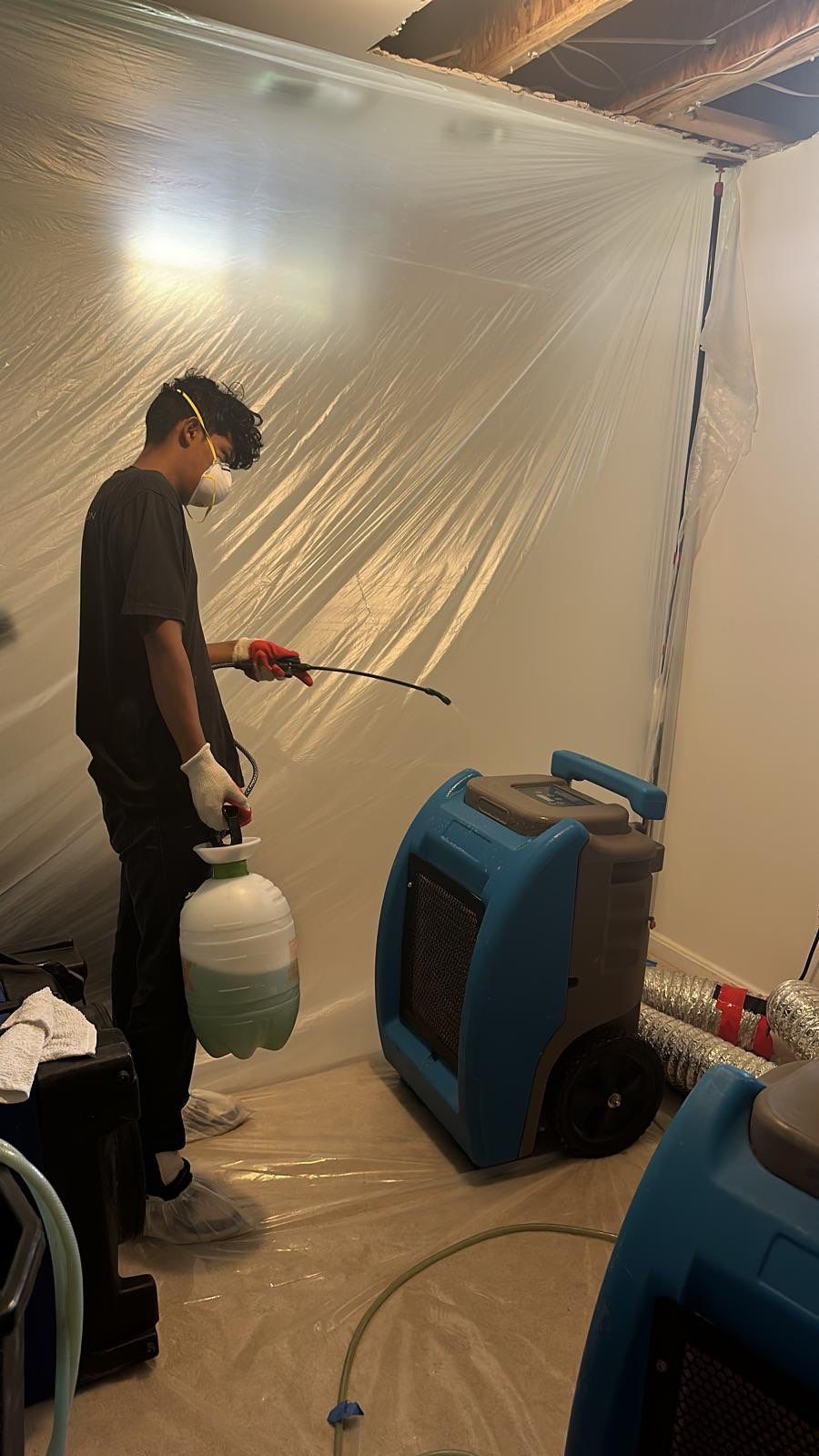 Final-stage water damage restoration in Chantilly with containment barrier and equipment removal underway.