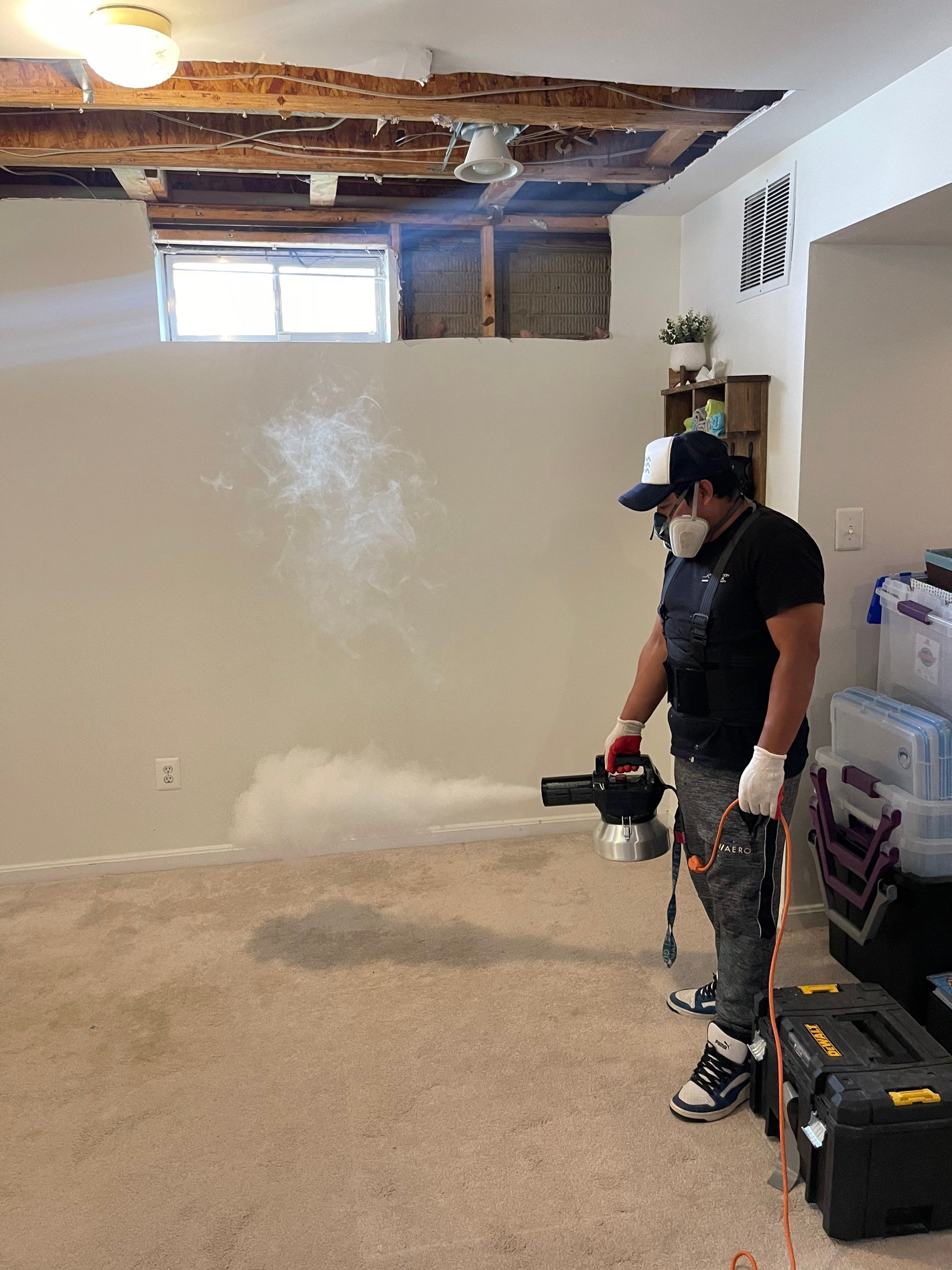 Structural drying in progress with dehumidifiers and air movers positioned throughout the affected area.