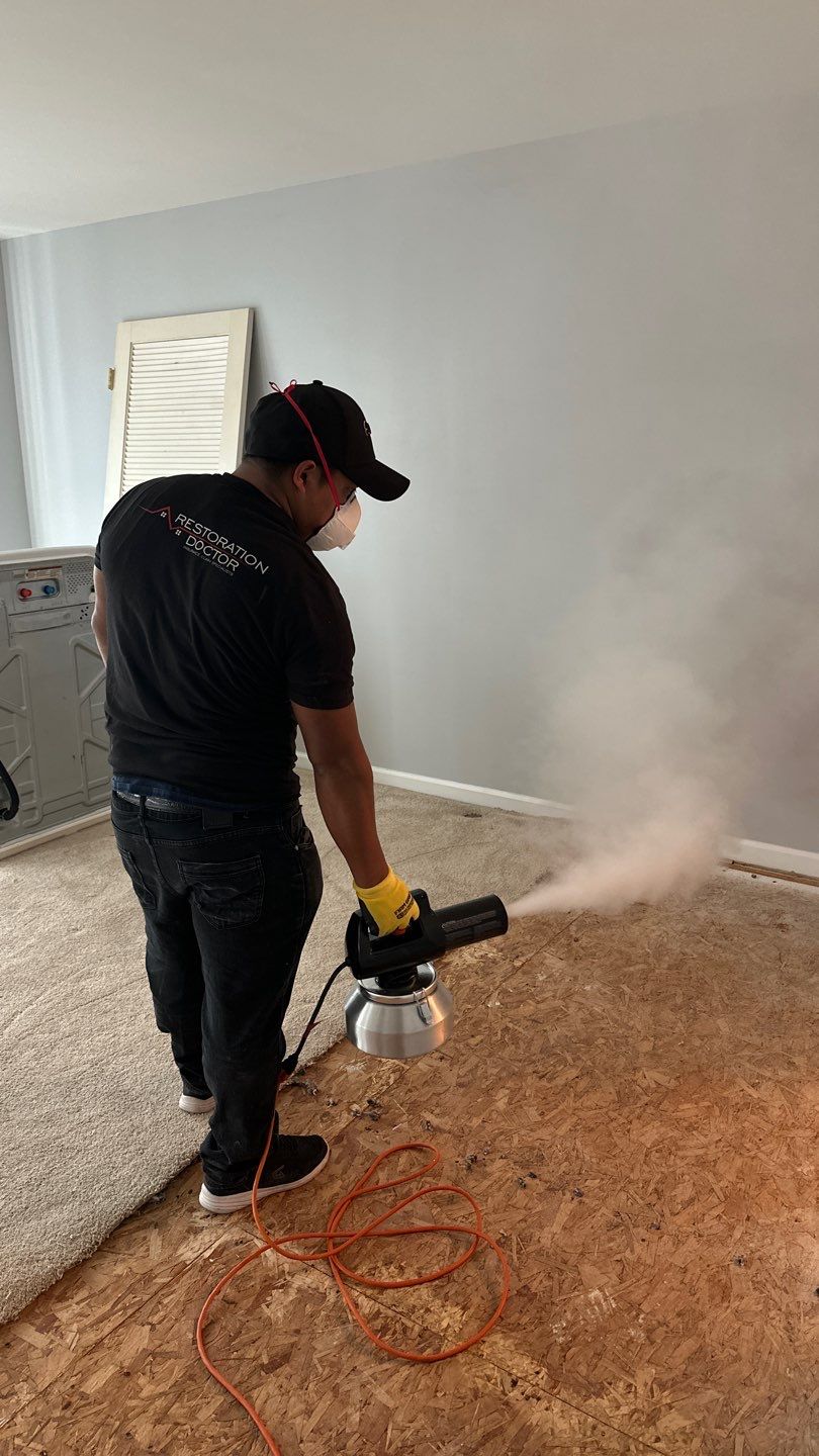 Water damage restoration in Manassas: dehumidifier and drying equipment deployed in affected interior space.