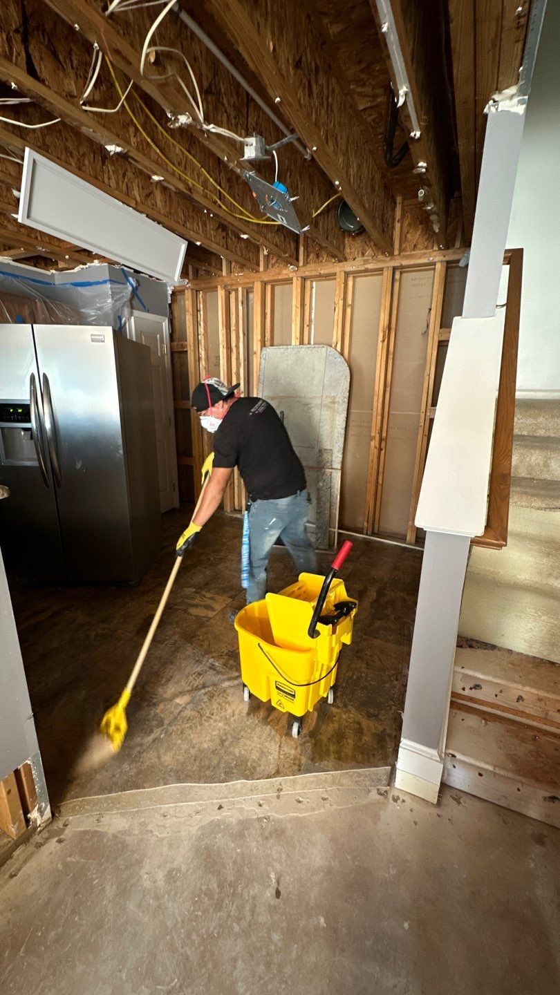Mid-stage drying setup showing dehumidification units and air circulation during water restoration work.