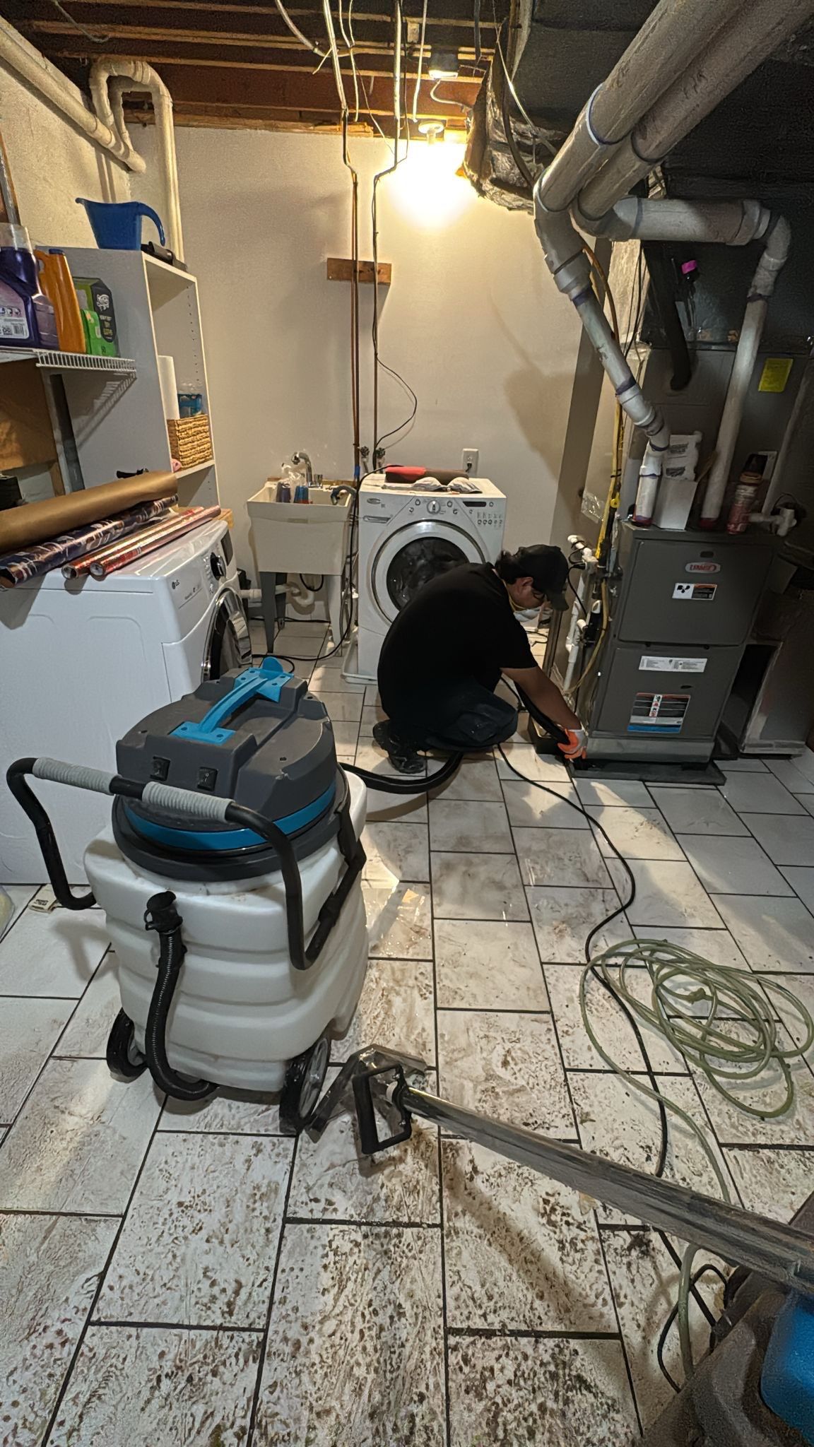 Dehumidifier and air movers positioned for structural drying during water damage mitigation.