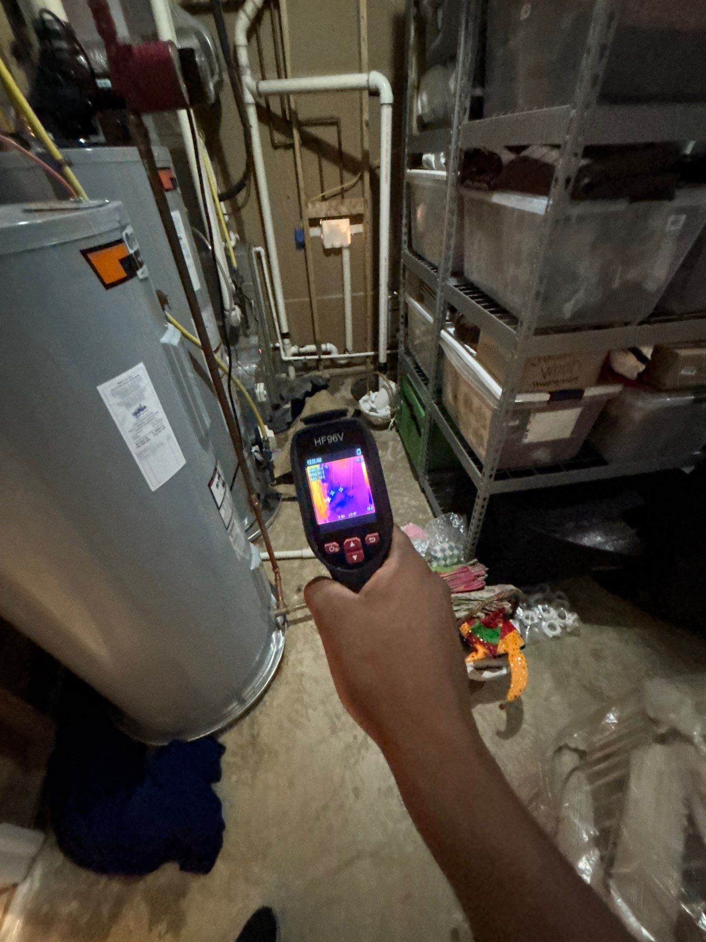 Water damage restoration in McLean: standing water and saturated materials from a tank leak in an interior space.