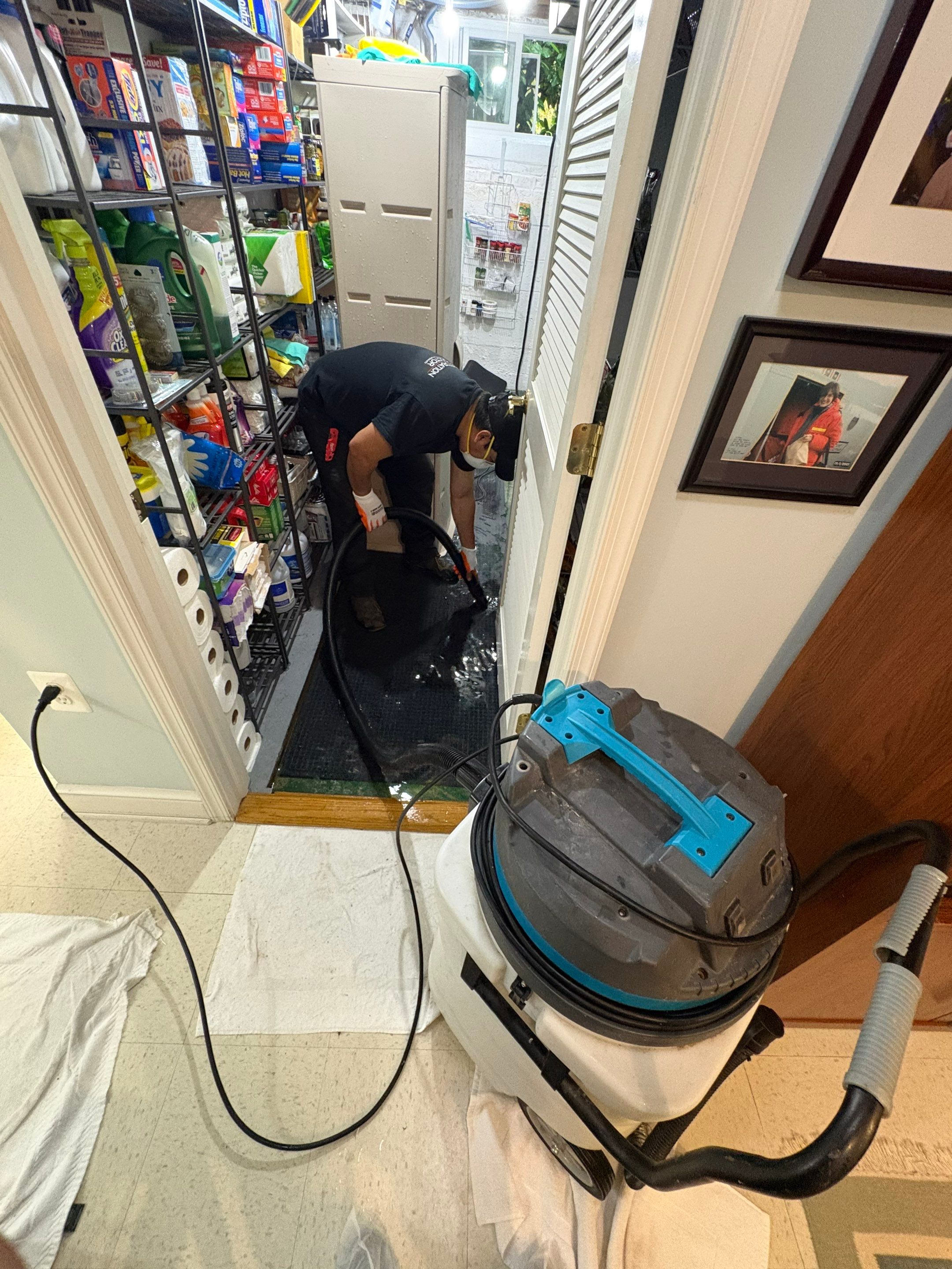 Structural drying setup with dehumidifiers and air movers deployed across water-damaged Arlington residence.