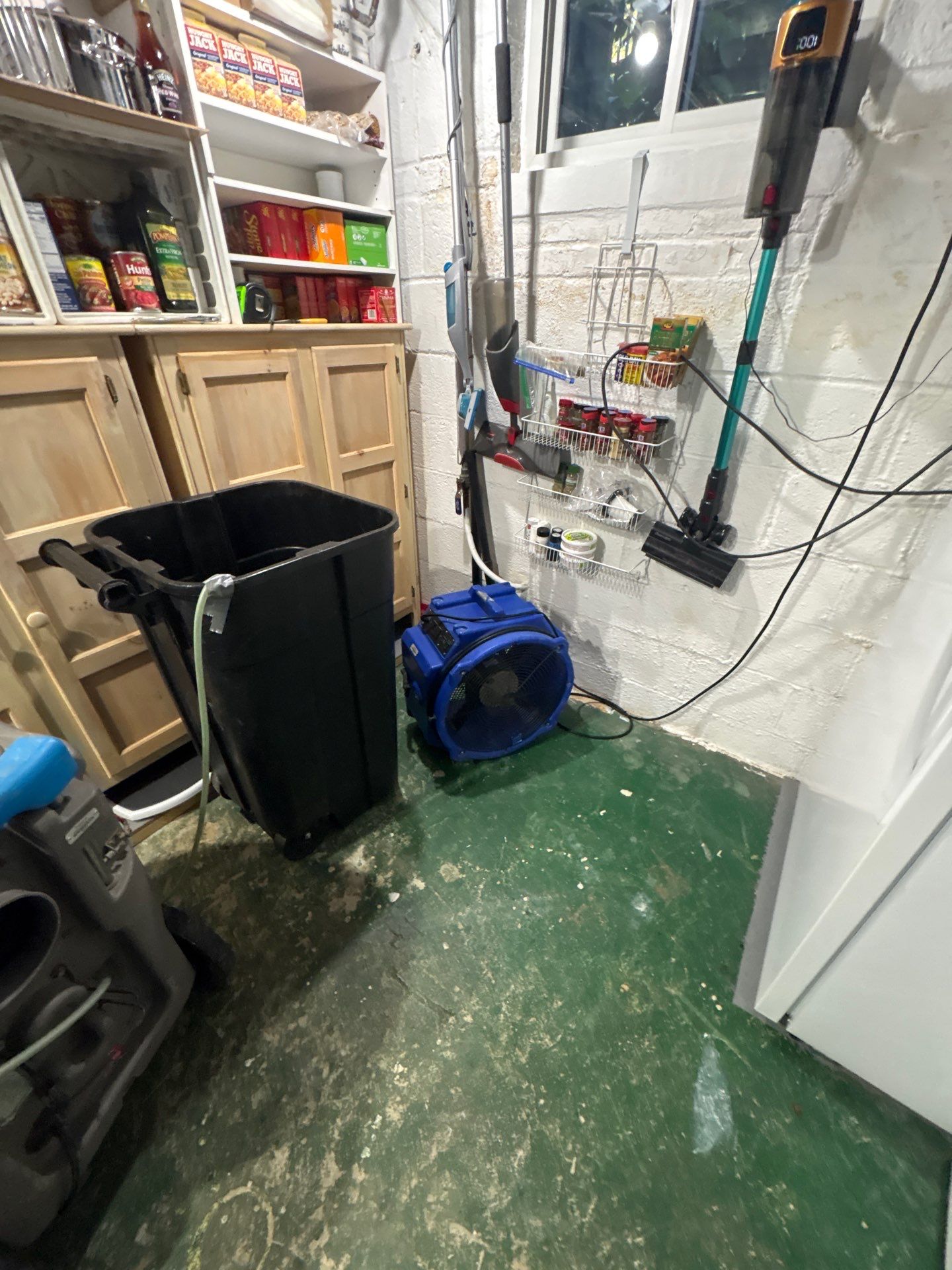 Industrial extraction equipment removing standing water from affected flooring during Arlington water restoration.