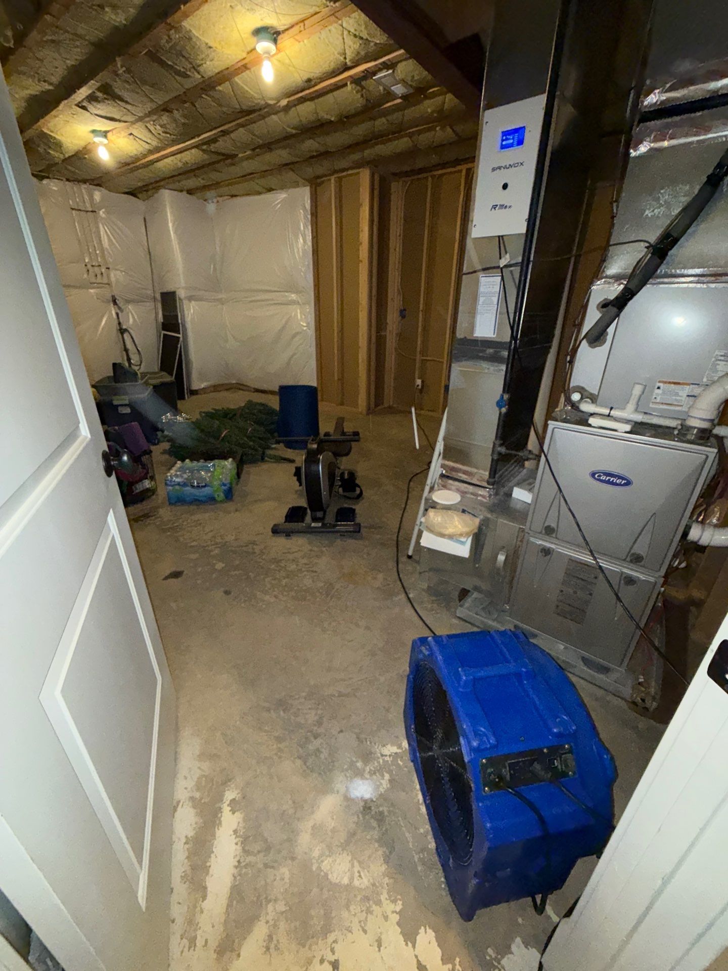 Contents staged and protected in Arlington as structural drying continues through remediation sequence.