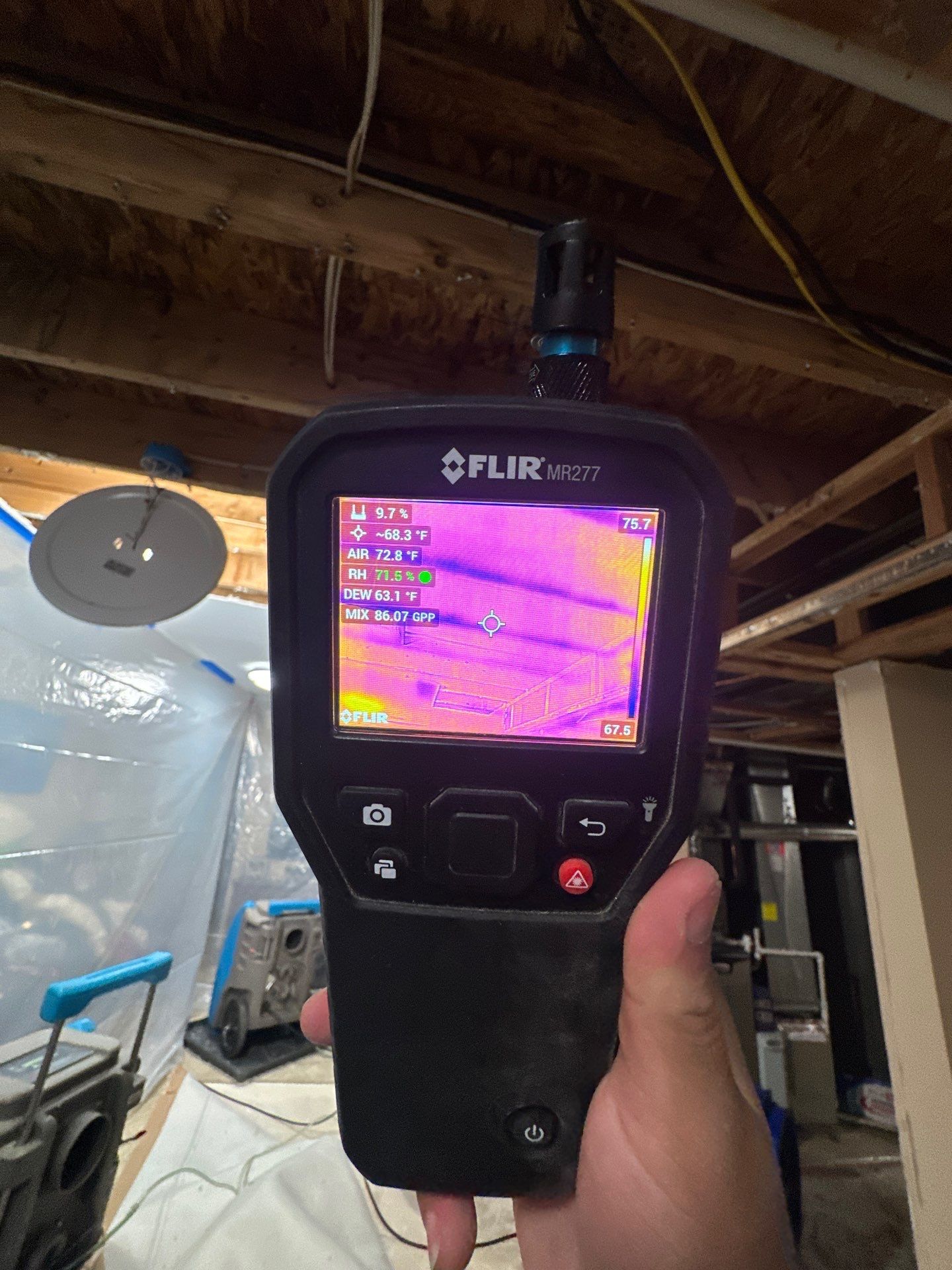 Dehumidification and air movement equipment continuing structural drying within containment.