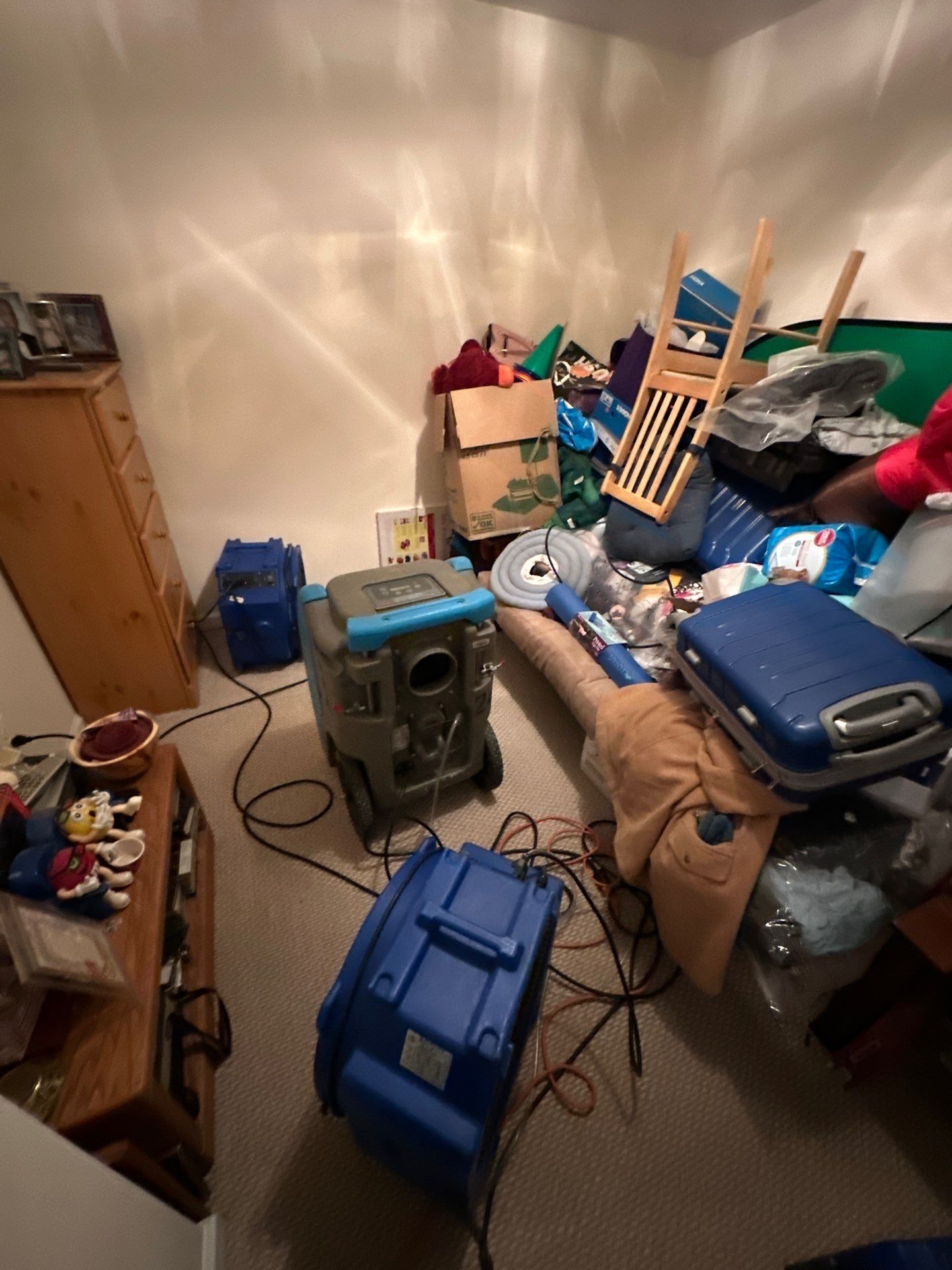 Dehumidifiers and air movers operating during mid-stage drying phase of Sterling water restoration.