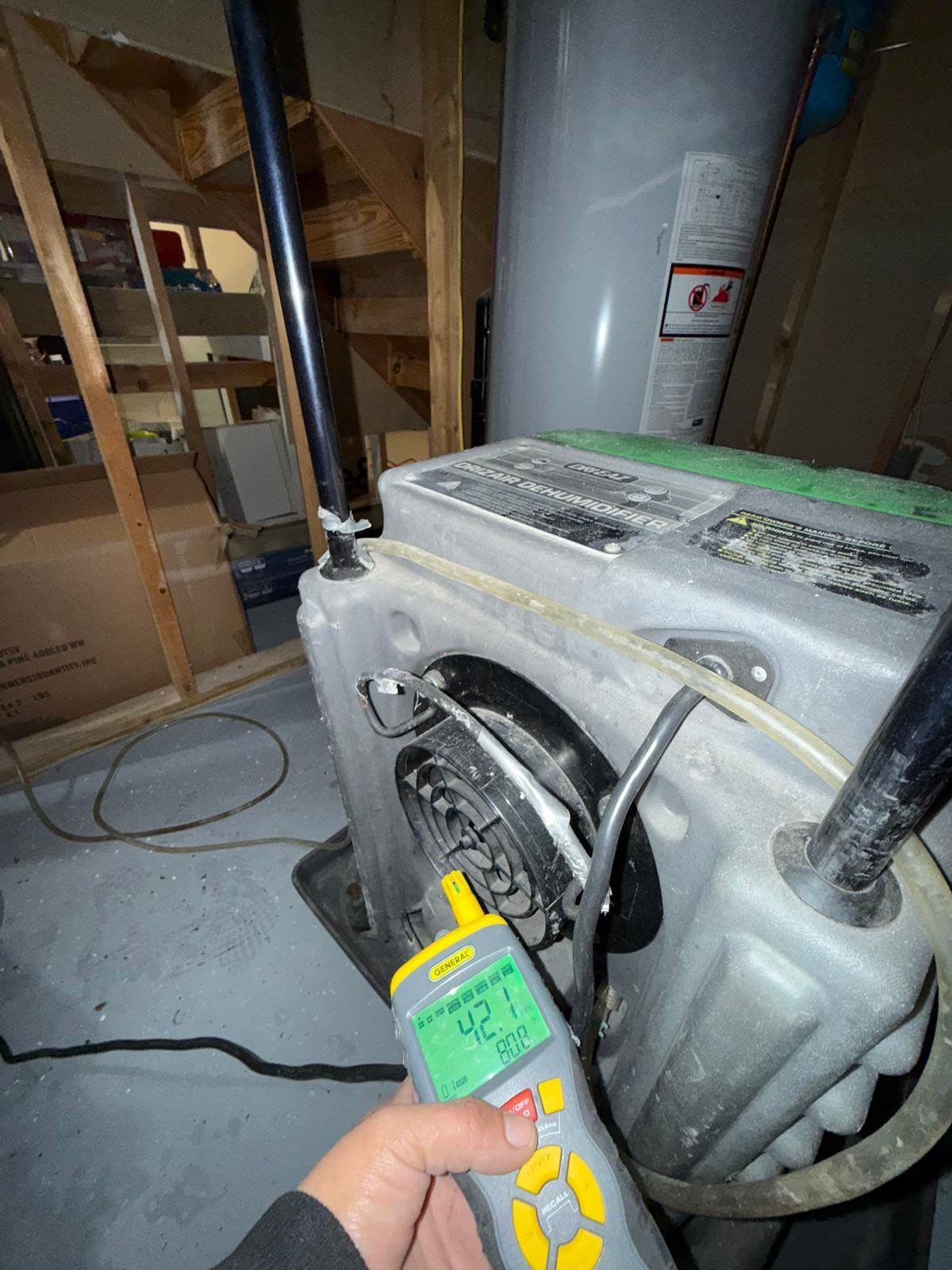 Standing water extraction underway in Oakton water damage restoration, wet flooring visible.