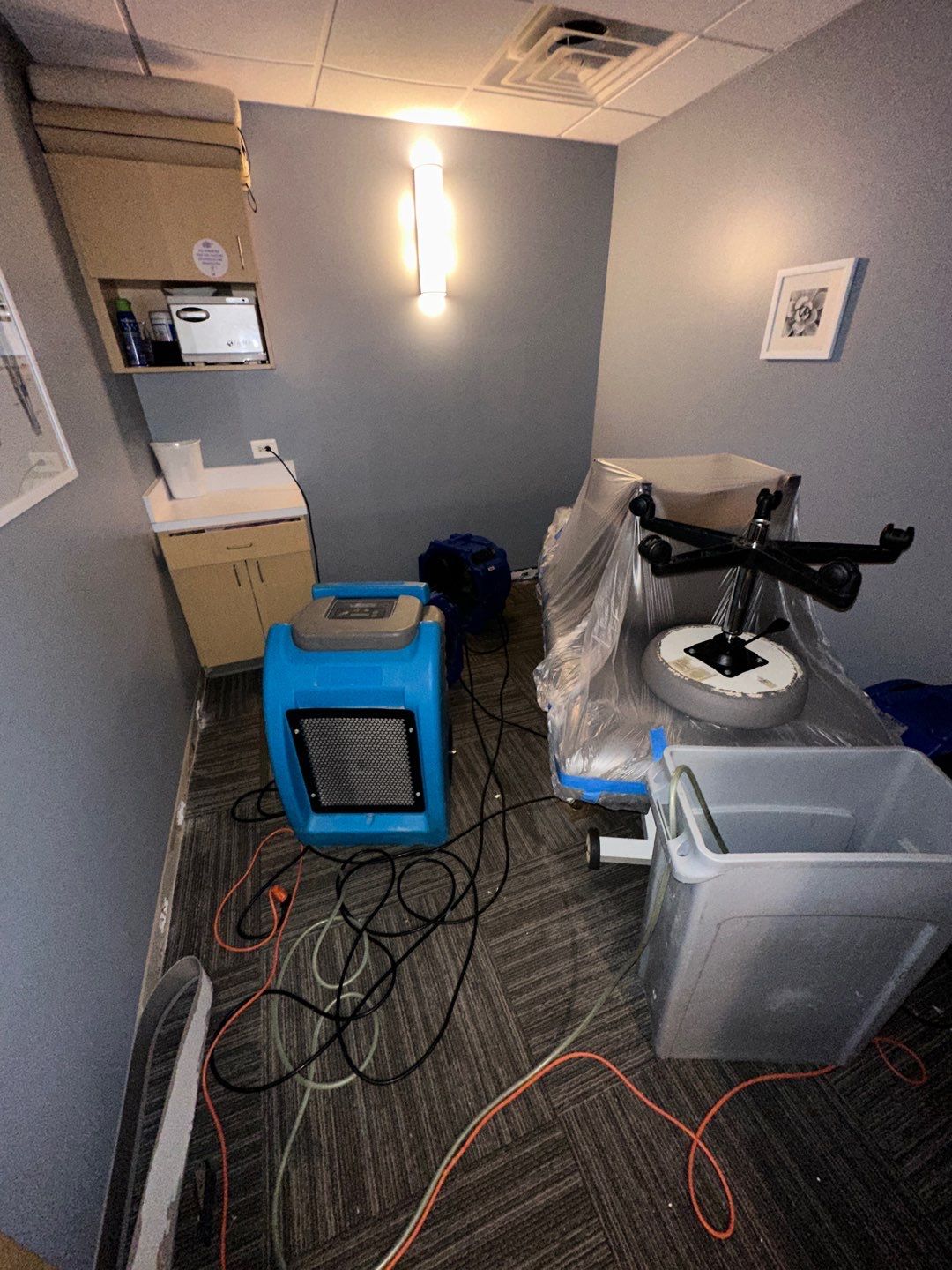 Advanced drying stage showing dehumidification progress with equipment repositioned to address remaining moisture in Vienna home.