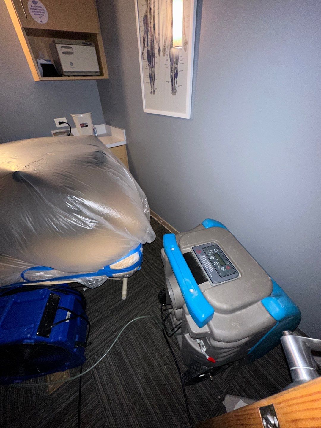 Water damage restoration in Vienna showing initial assessment with dehumidification equipment positioned for structural drying.