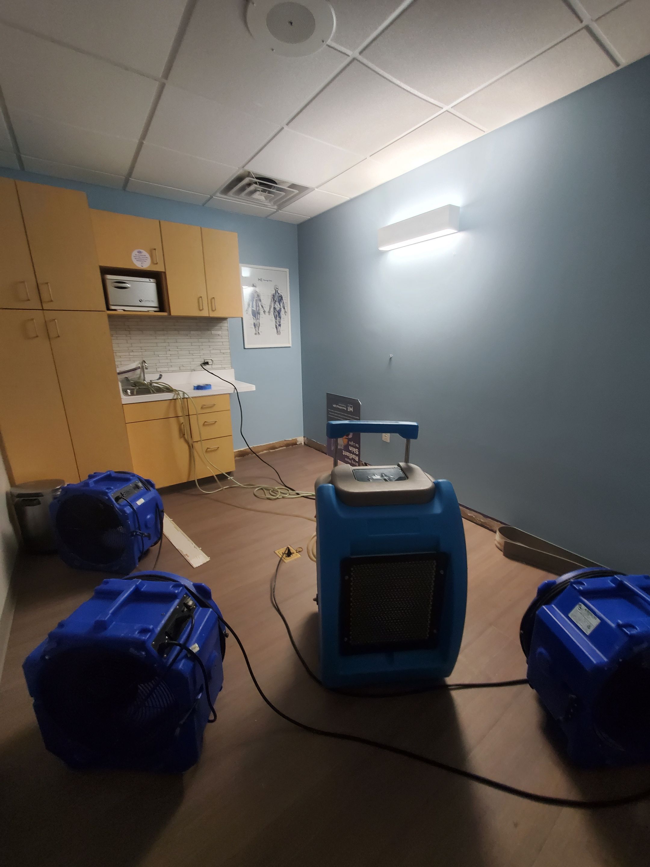 Continued structural drying phase with equipment placement optimized for airflow and moisture extraction during restoration.