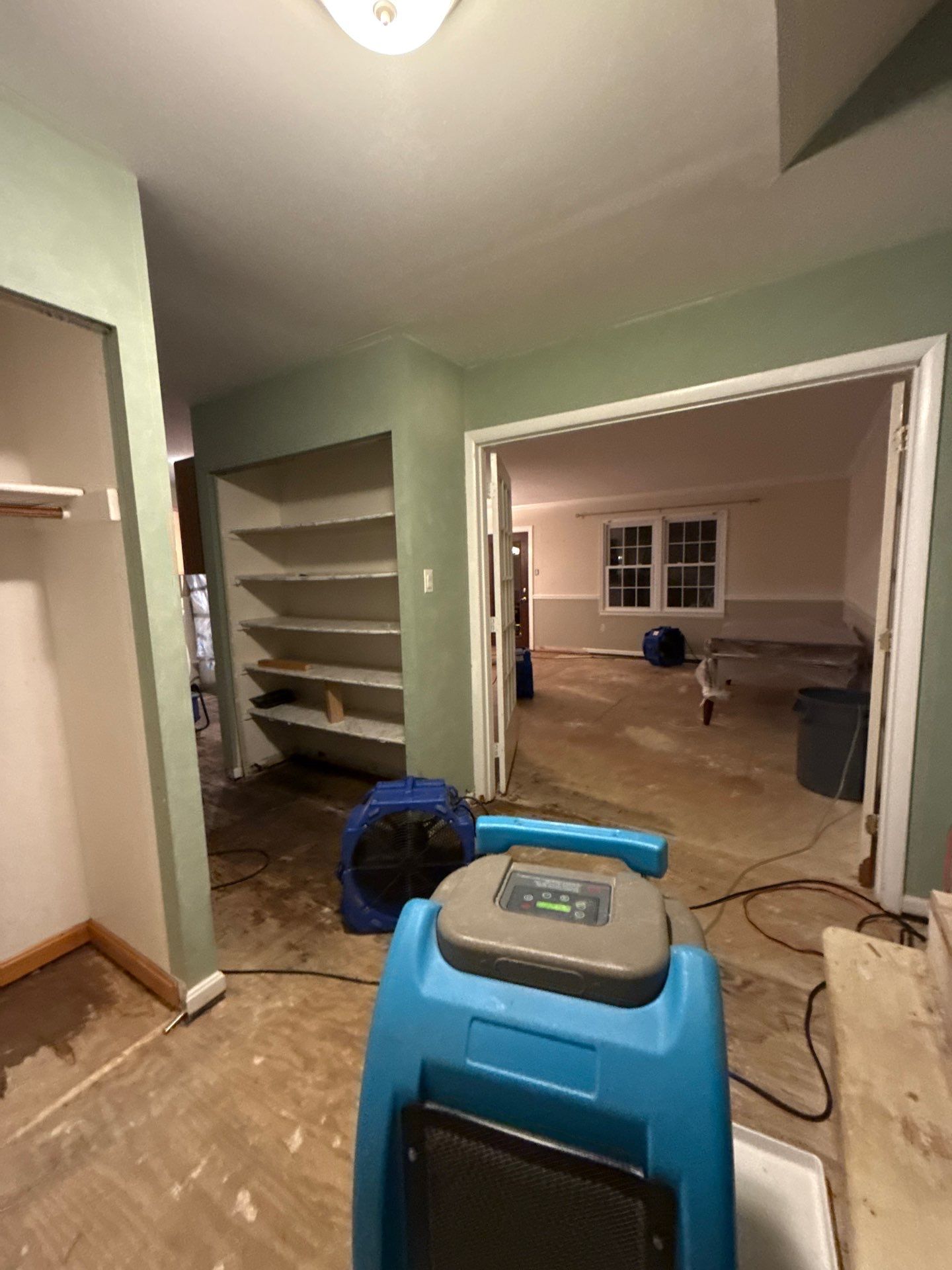 Containment and drying setup showing negative air management during wall replacement phase.