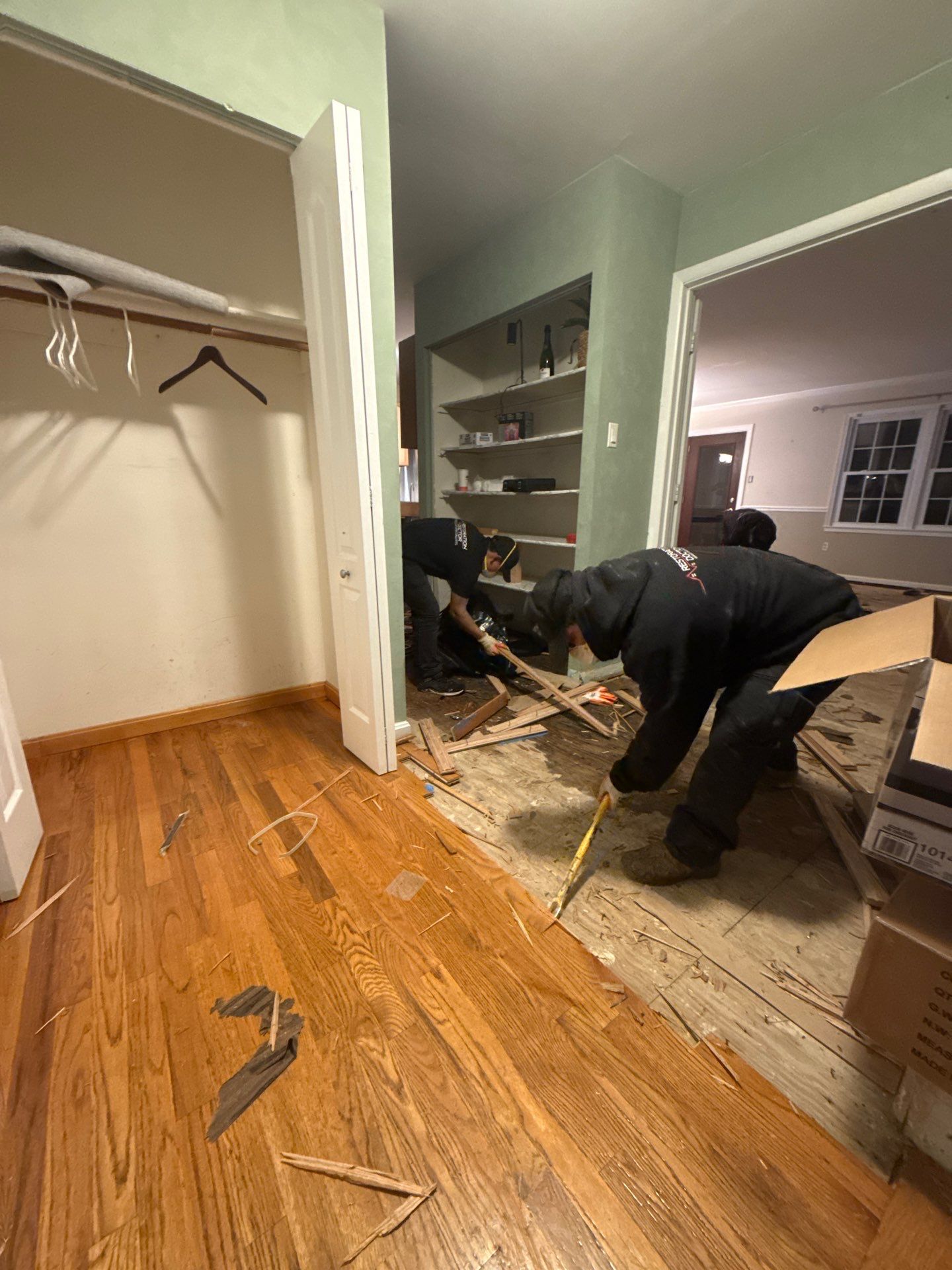 Structural drying in progress with dehumidifiers and air movers positioned throughout the space.