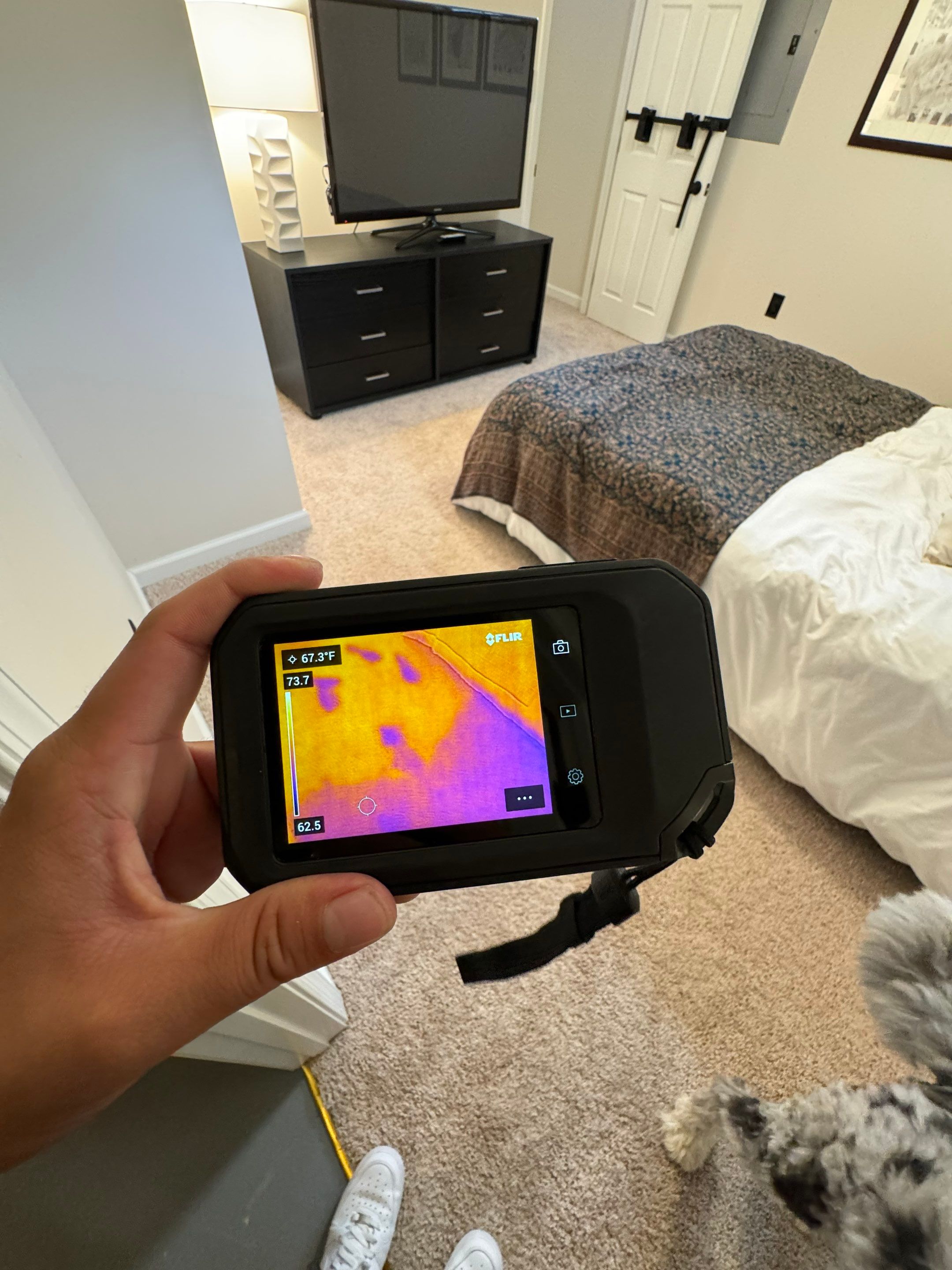 Moisture mapping equipment monitoring drying progress across affected wall and floor surfaces.