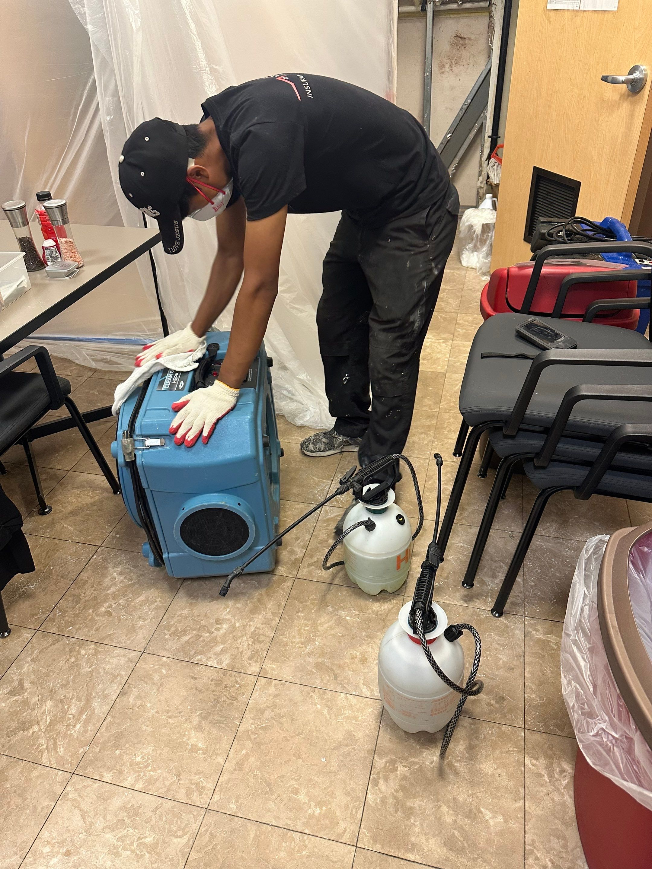 Containment barrier and dehumidifier setup during water damage restoration in Ashburn, Virginia.