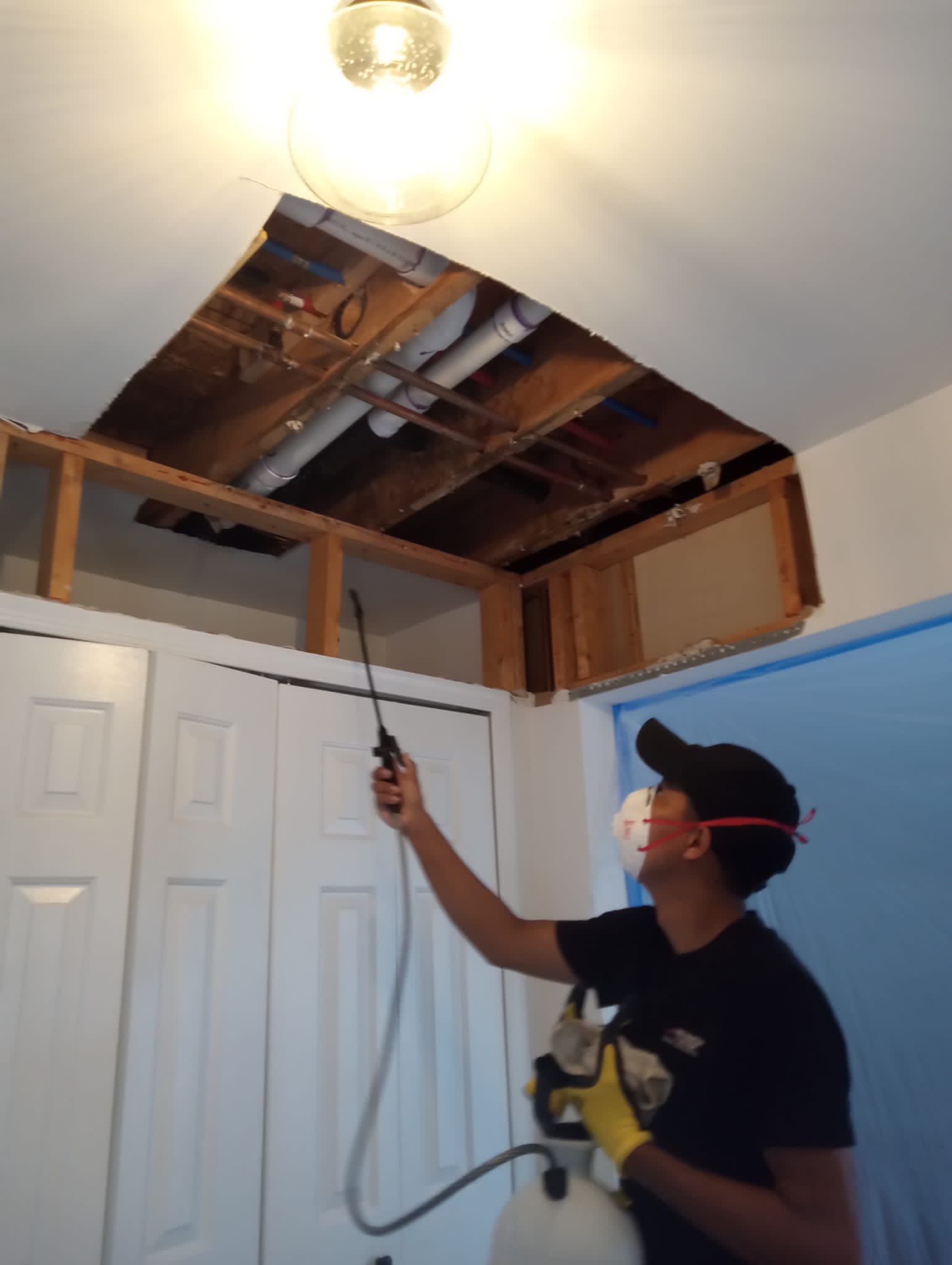 Dehumidification equipment positioned for structural drying in water-affected interior space.