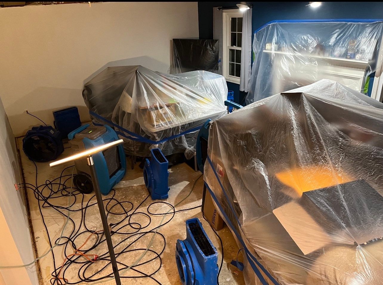 Structural drying in progress: dehumidifiers and air movers working to extract residual moisture from affected framing and materials.