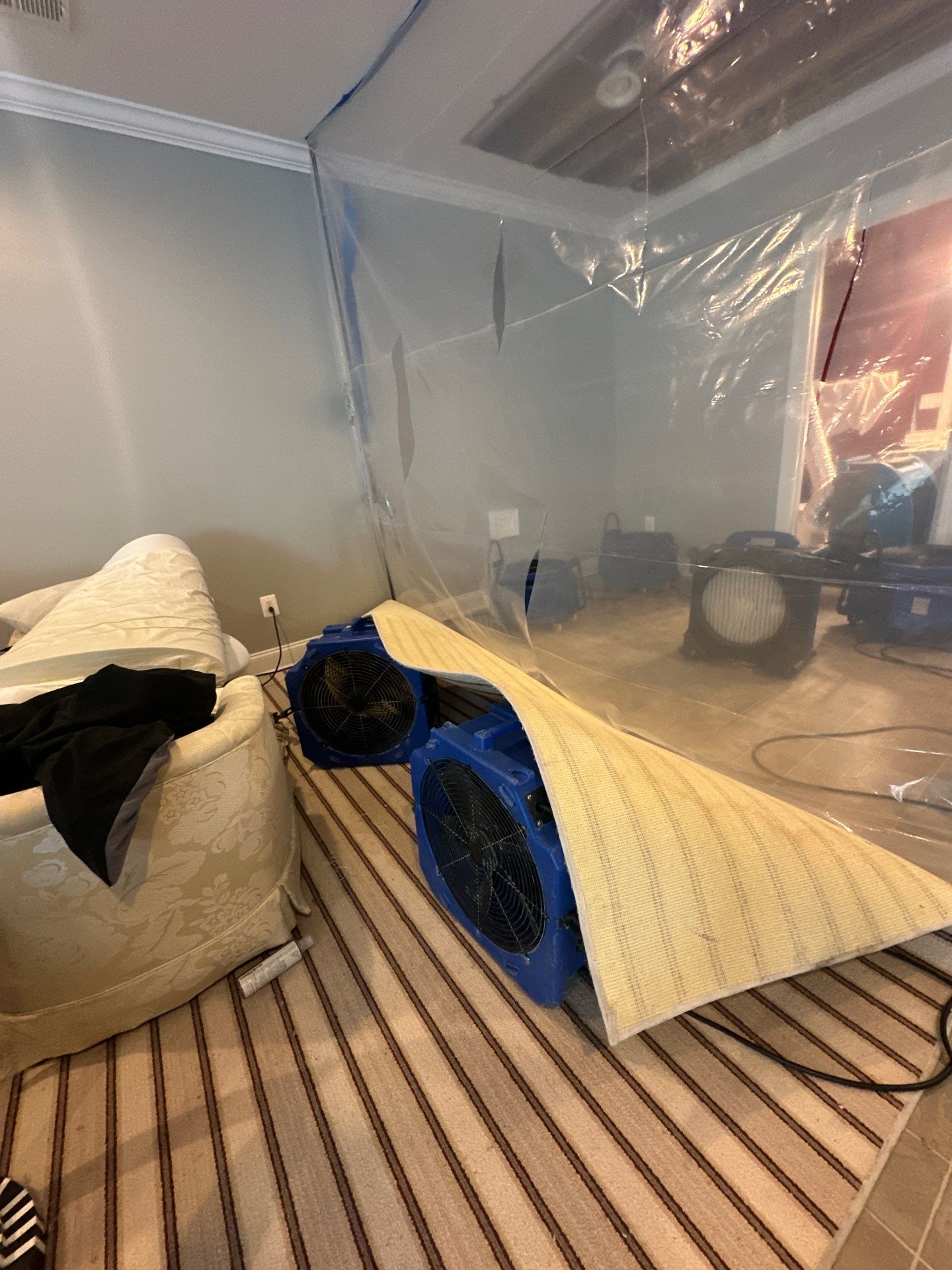 Containment and drying setup showing targeted moisture removal from compromised ceiling assembly.
