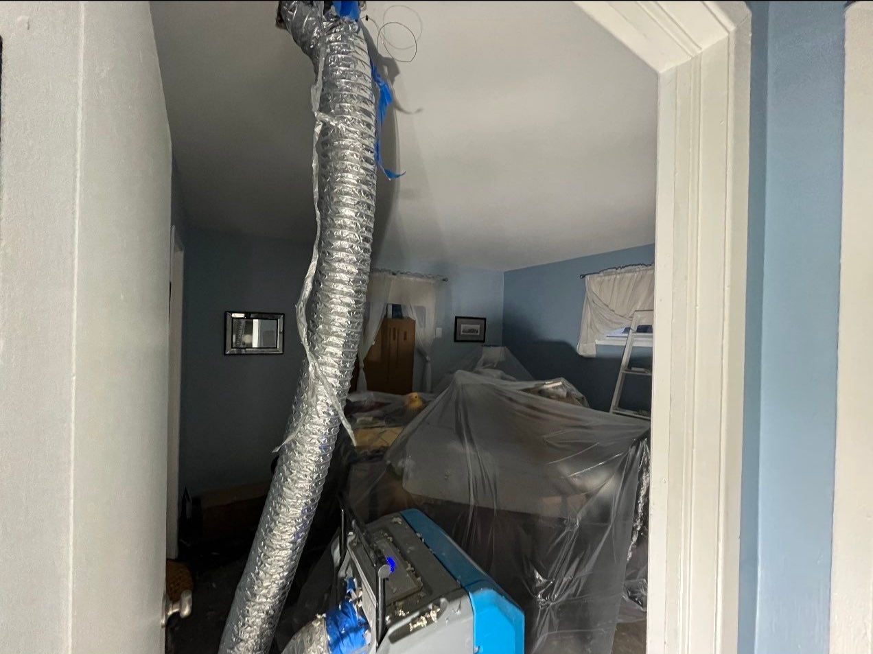 Thermal imaging reveals moisture distribution across wall cavity during Alexandria water damage assessment.
