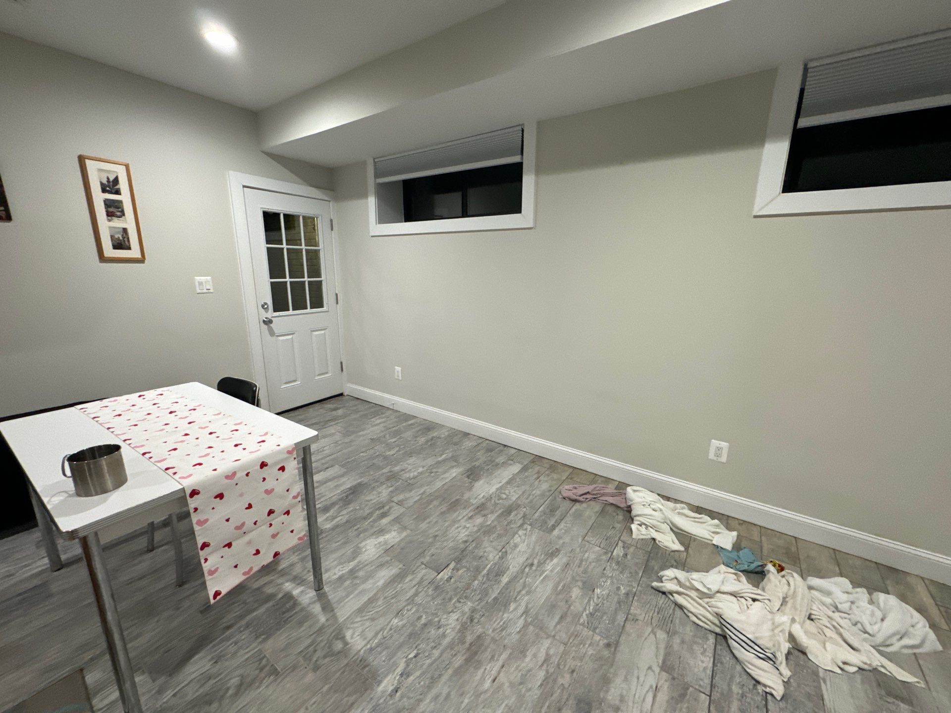 Water-damaged carpet and subfloor in Alexandria home during initial assessment and moisture documentation.