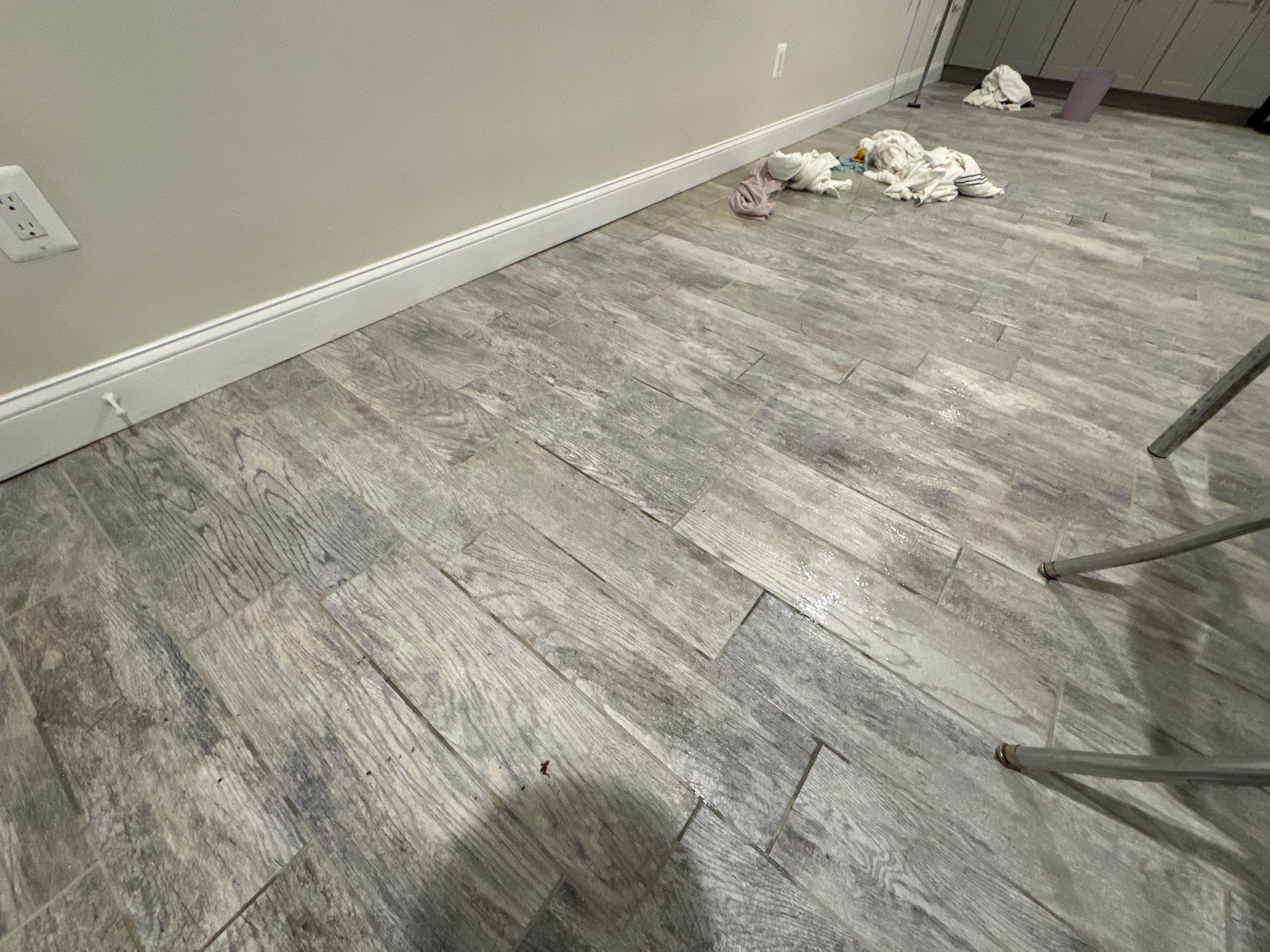 Moisture monitoring equipment tracking drying progress on affected flooring materials.
