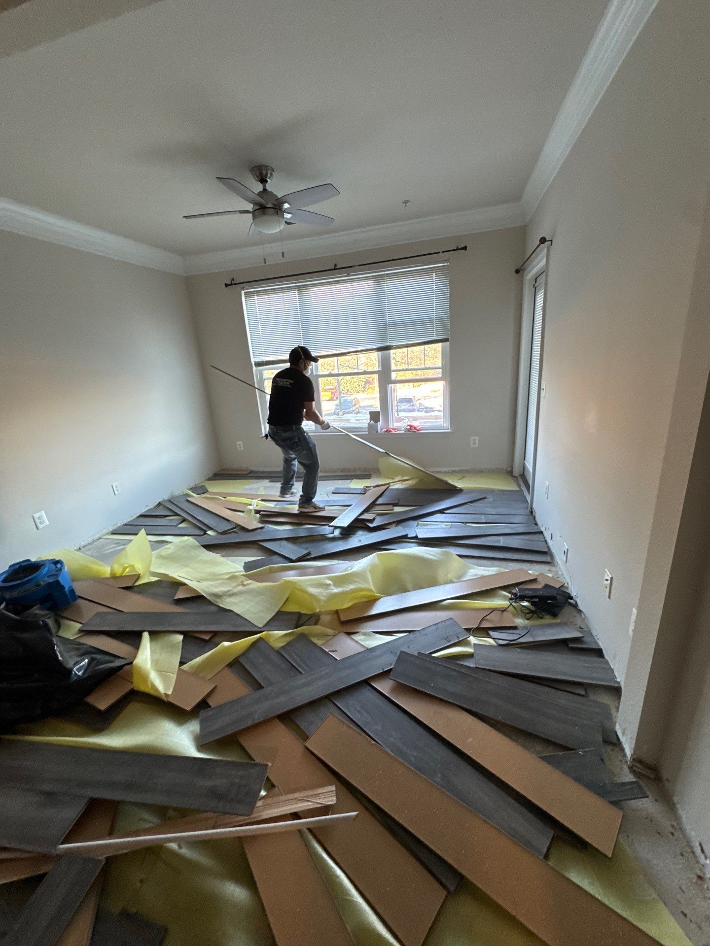Carpet removal and flooring preparation during mold remediation, exposing substrate for cleaning and treatment.