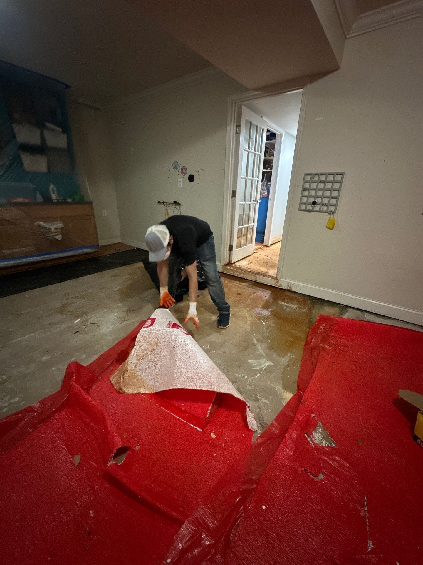 Standing water extraction underway in Manassas home, removal equipment positioned for water damage restoration.