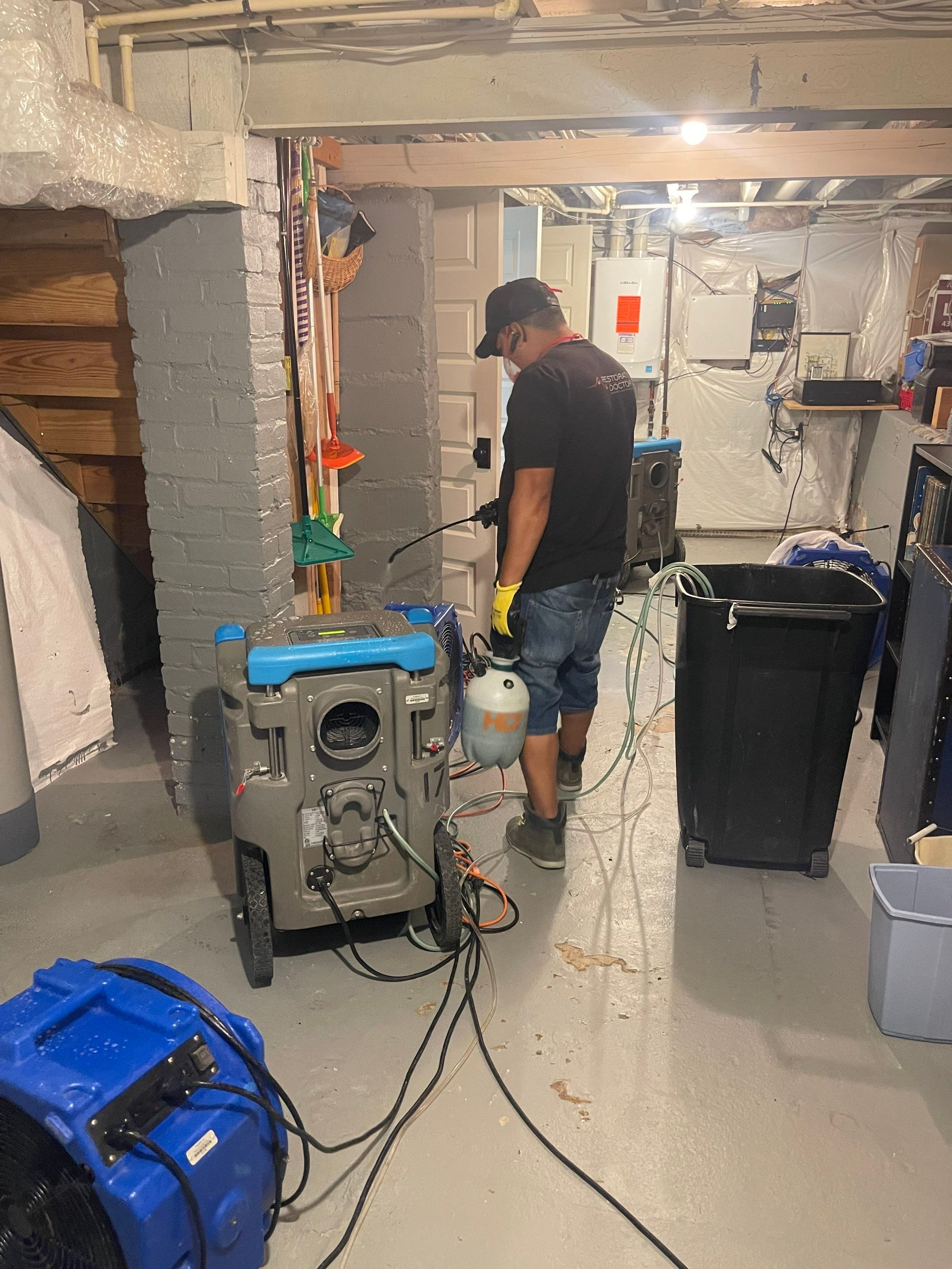 Standing water extraction underway in Arlington water damage restoration, portable extractors removing pooled water from flooring.